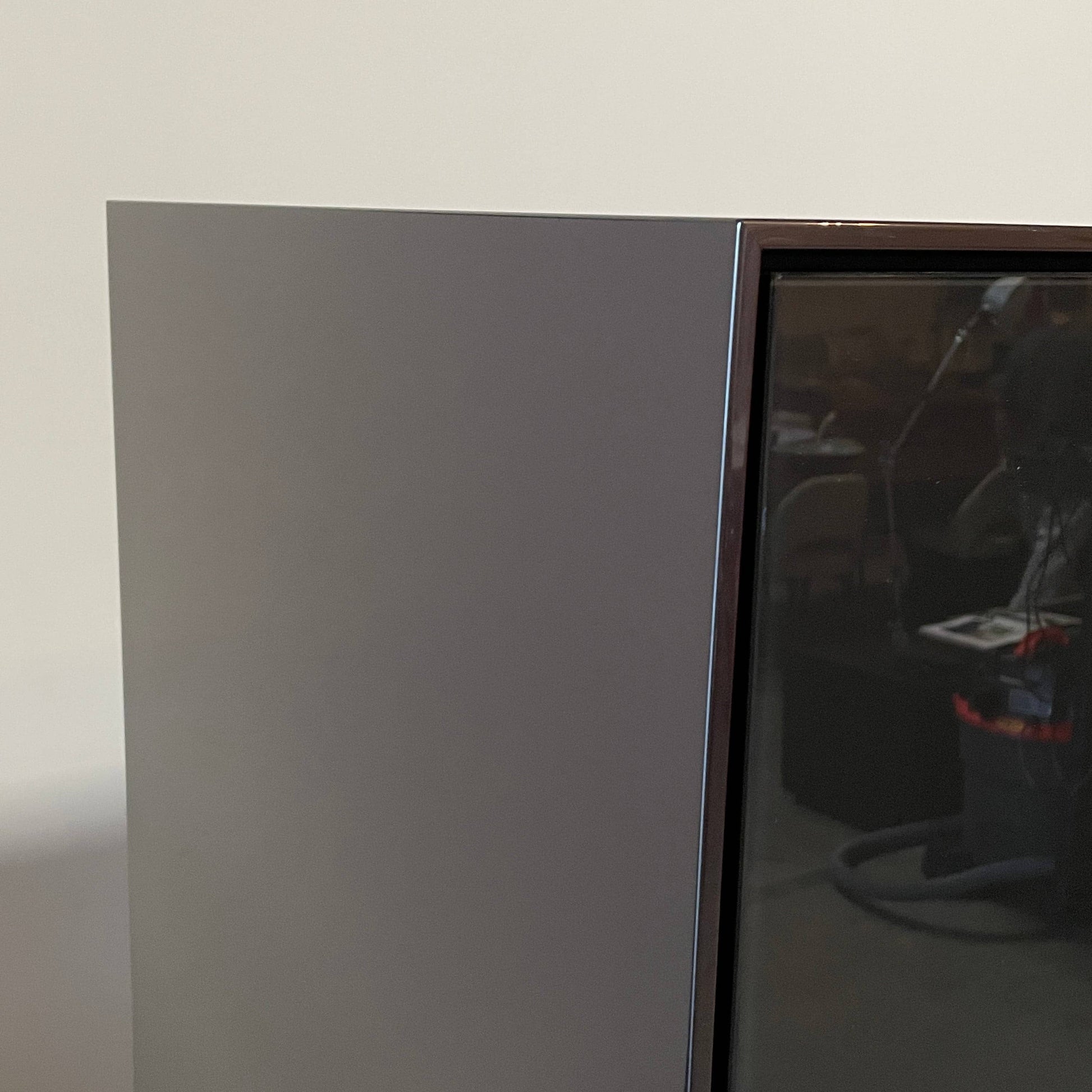 The B&B Italia Eucalipto Living Storage Unit is a sleek black metal cabinet with one drawer, two doors, and slim legs. It offers a minimalist and modern design, perfect for sophisticated bar storage.