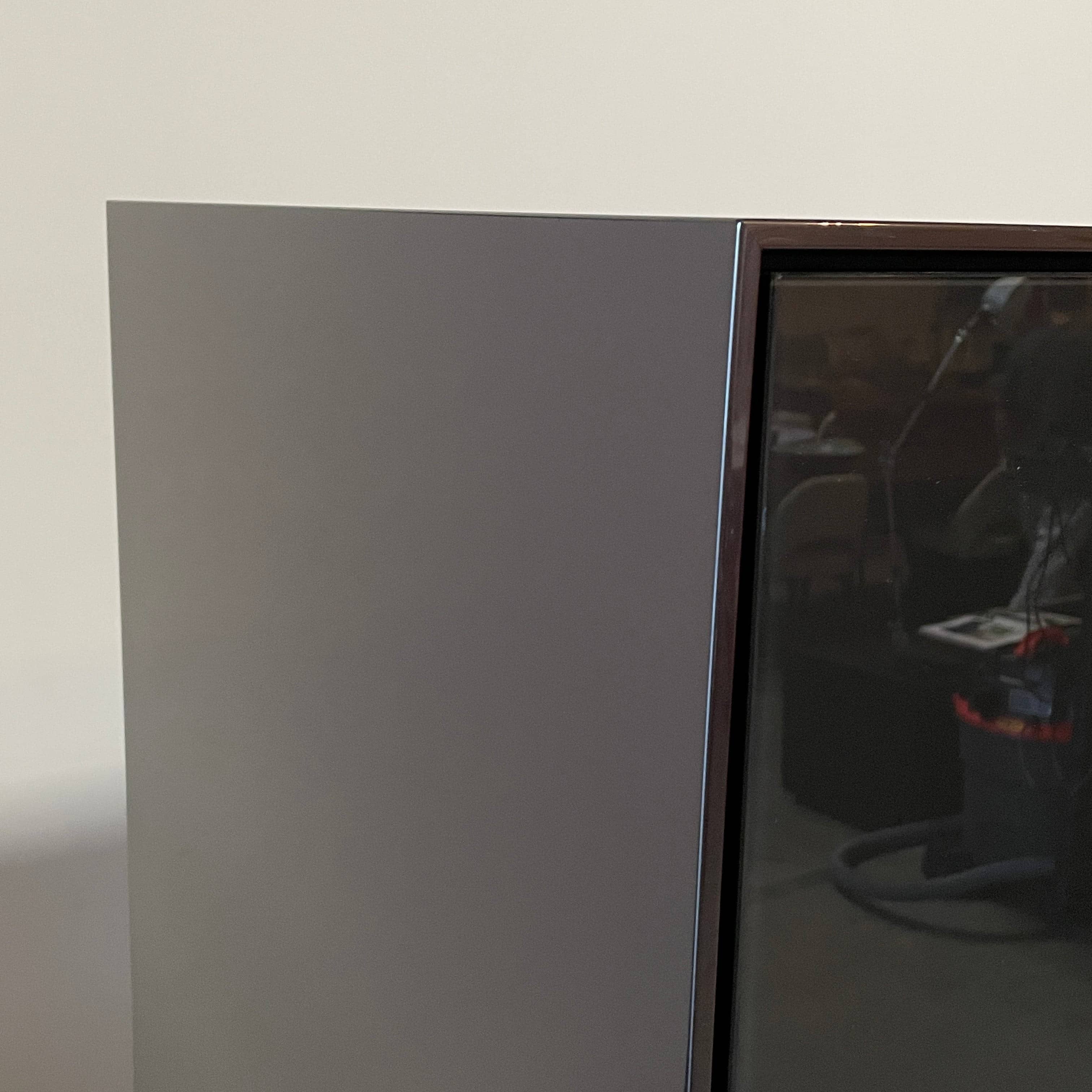 The B&B Italia Eucalipto Living Storage Unit is a sleek black metal cabinet with one drawer, two doors, and slim legs. It offers a minimalist and modern design, perfect for sophisticated bar storage.