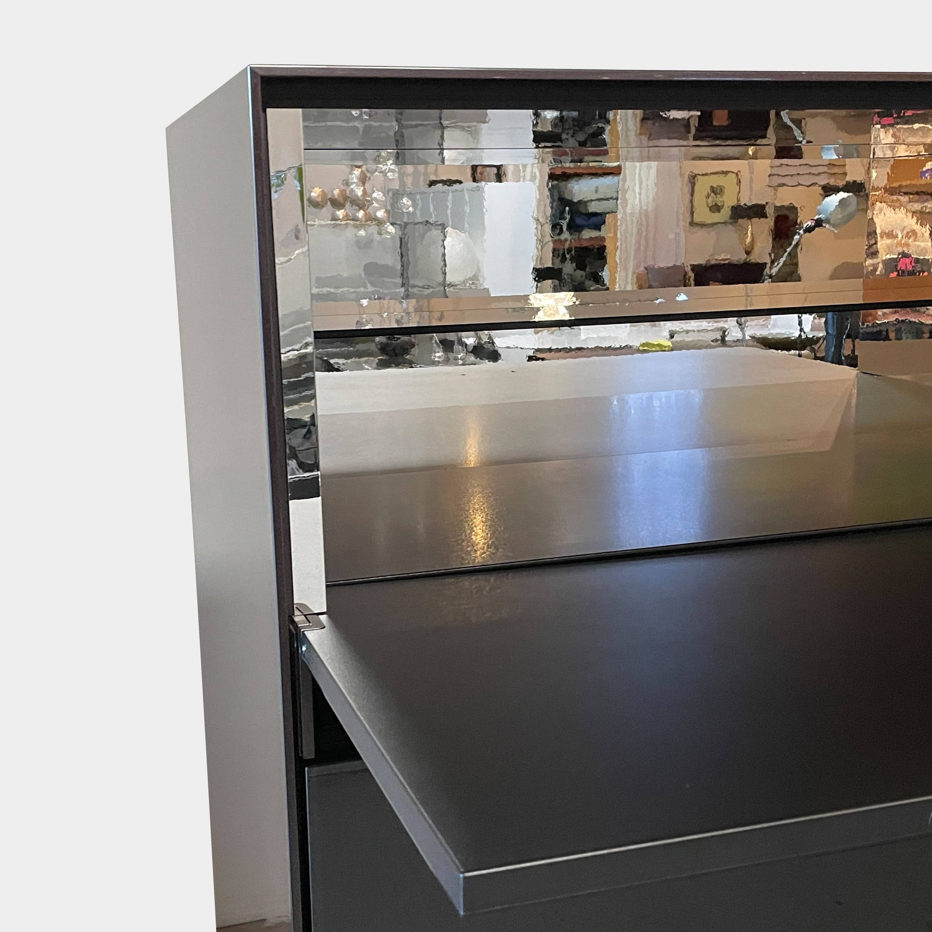 The B&B Italia Eucalipto Living Storage Unit is a sleek black metal cabinet with one drawer, two doors, and slim legs. It offers a minimalist and modern design, perfect for sophisticated bar storage.