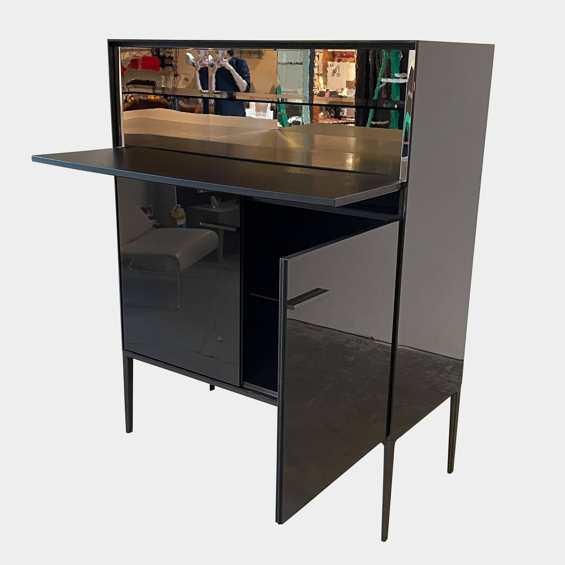 The B&B Italia Eucalipto Living Storage Unit is a sleek black metal cabinet with one drawer, two doors, and slim legs. It offers a minimalist and modern design, perfect for sophisticated bar storage.