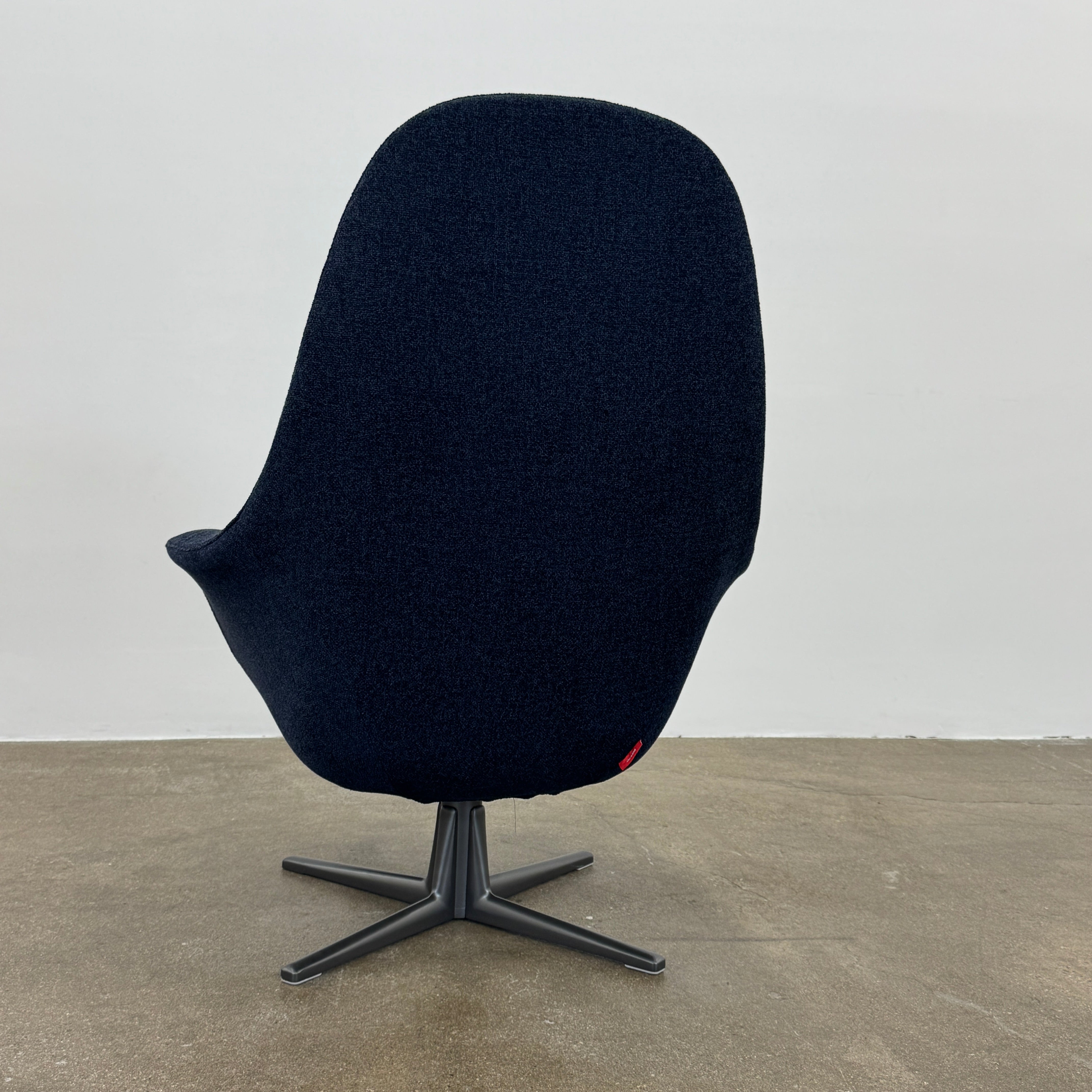 The Flexform Marlon Swivel Armchair and Ottoman, available with two covers, feature ergonomic design and black metal bases from Flexform, shown here in a modern gray finish against a plain white background.