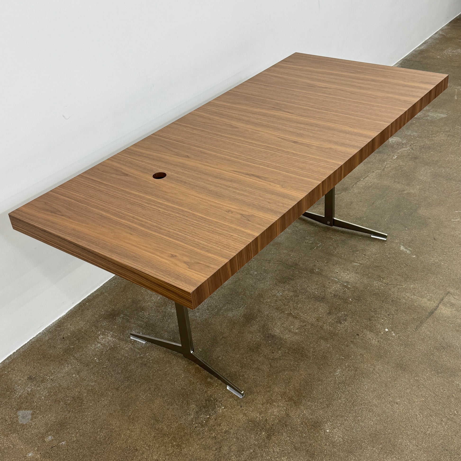 The Flexform Fly Canaletto Walnut Desk is a custom wood desk with a central circular cable management hole, reflecting the refined style of Flexform.