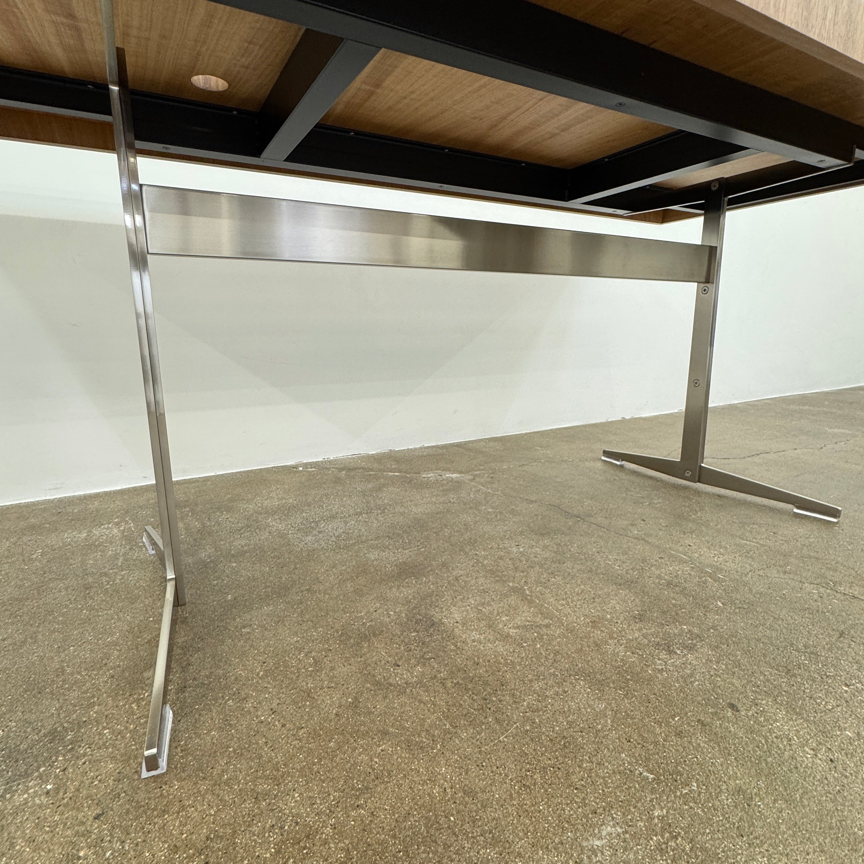 The Flexform Fly Canaletto Walnut Desk is a custom wood desk with a central circular cable management hole, reflecting the refined style of Flexform.