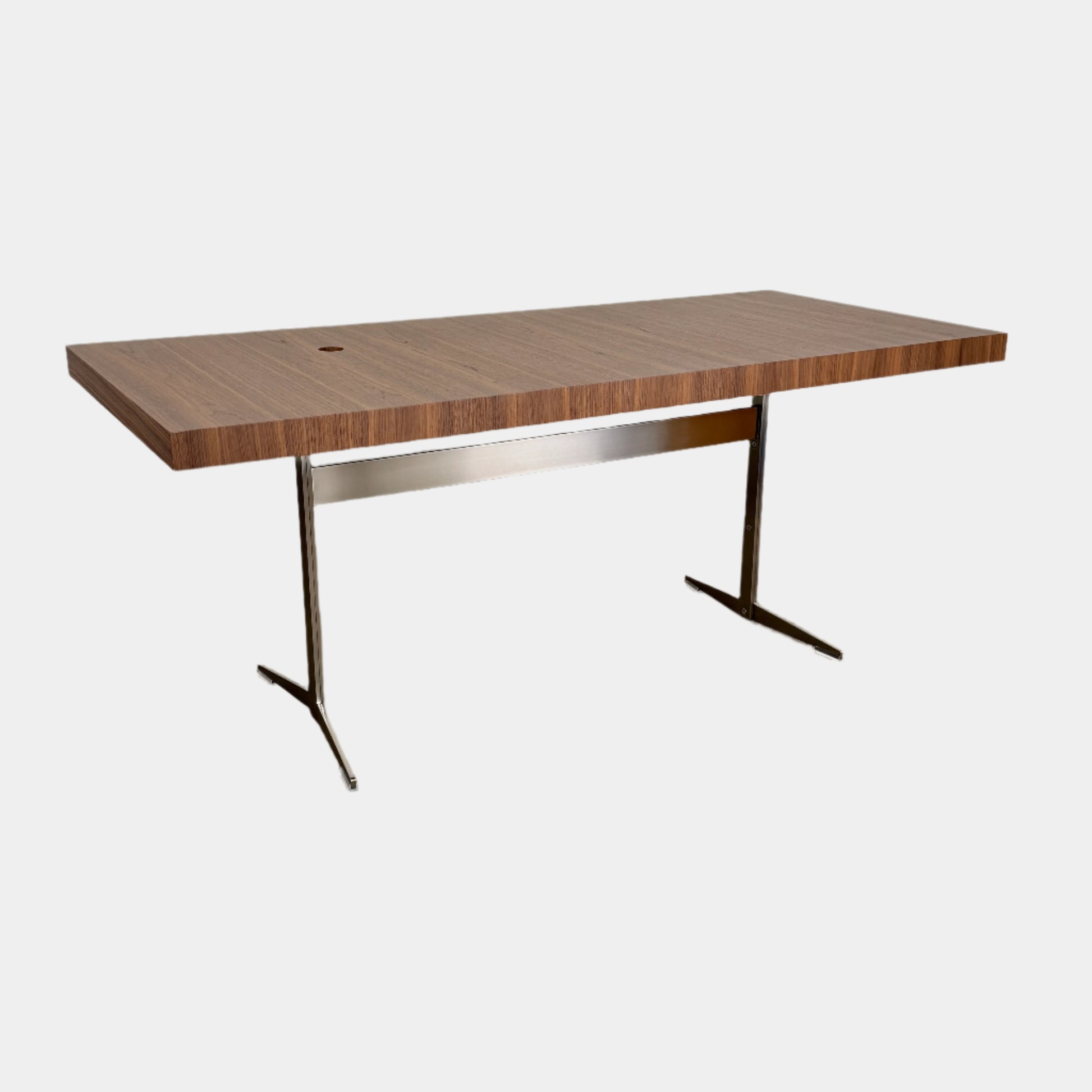 The Flexform Fly Canaletto Walnut Desk is a custom wood desk with a central circular cable management hole, reflecting the refined style of Flexform.