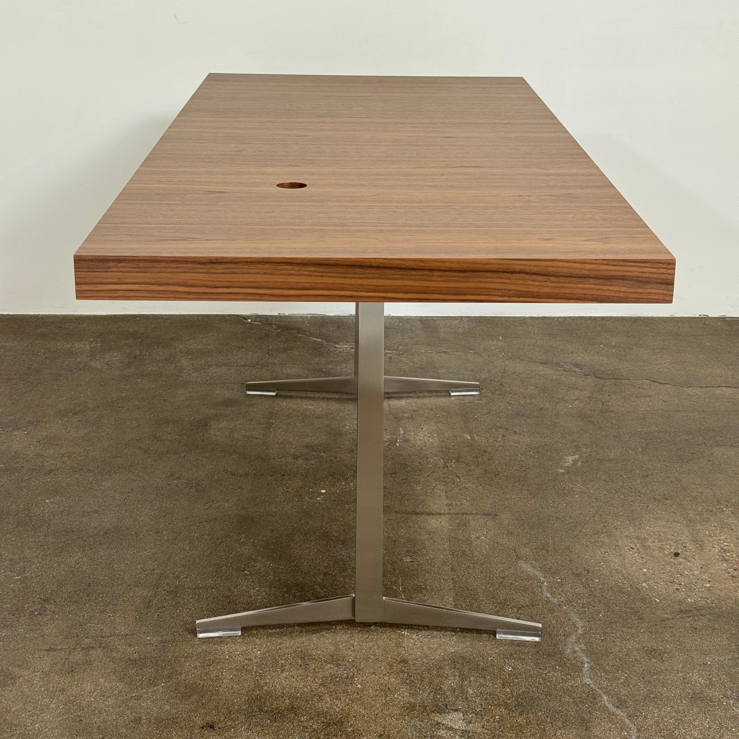 The Flexform Fly Canaletto Walnut Desk is a custom wood desk with a central circular cable management hole, reflecting the refined style of Flexform.