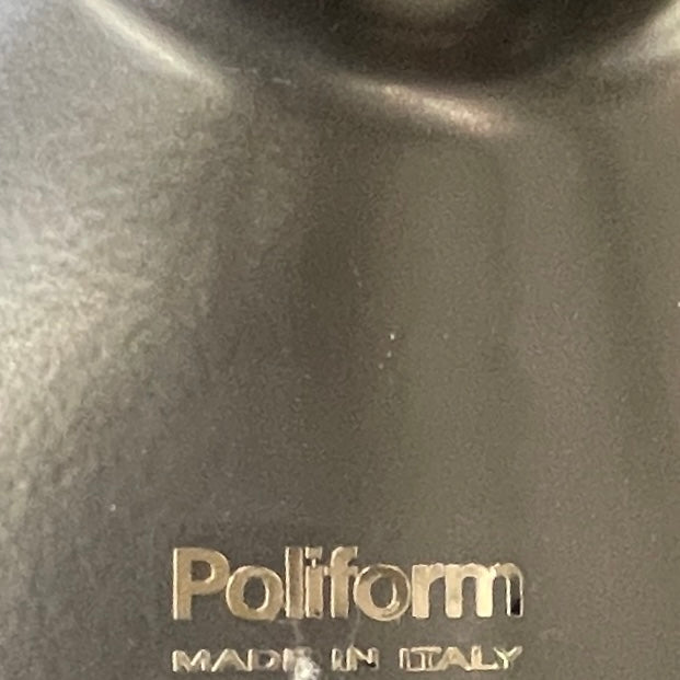 The Poliform Mondrian Lacquered Coffee Table showcases a round blue top with a black, four-legged metal base against a white background.