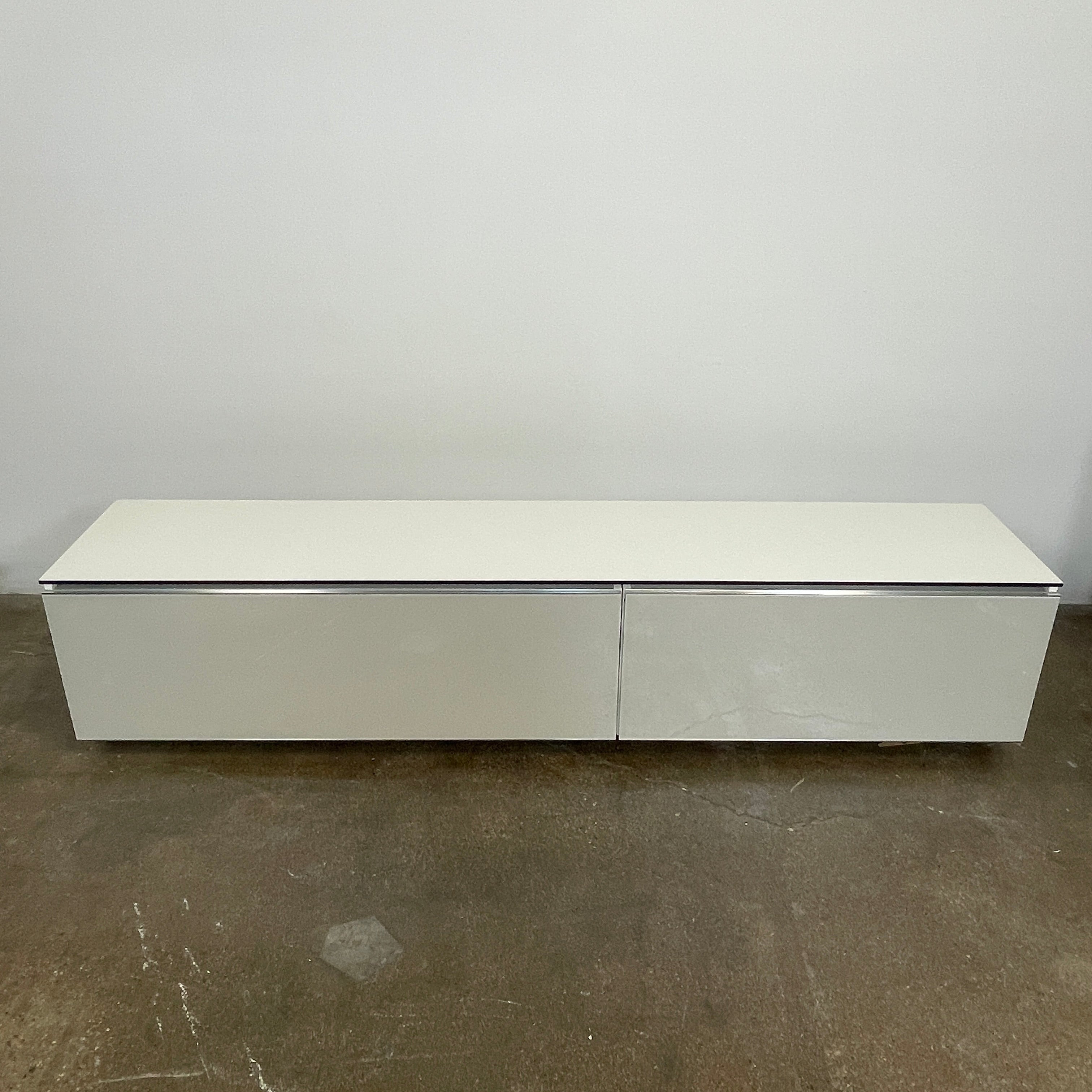 The B&B Italia Pab Low Console by B&B Italia is a rectangular, low-profile media console with glossy pearl white doors and two doors, perfect for stylish storage, shown against a plain white background.