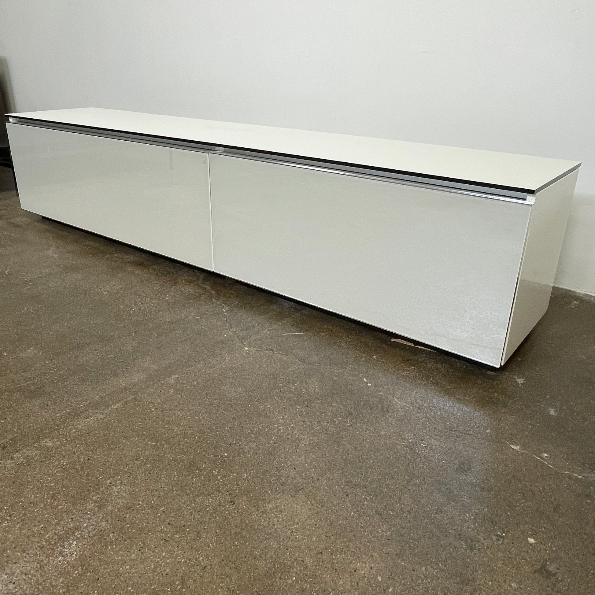 The B&B Italia Pab Low Console by B&B Italia is a rectangular, low-profile media console with glossy pearl white doors and two doors, perfect for stylish storage, shown against a plain white background.
