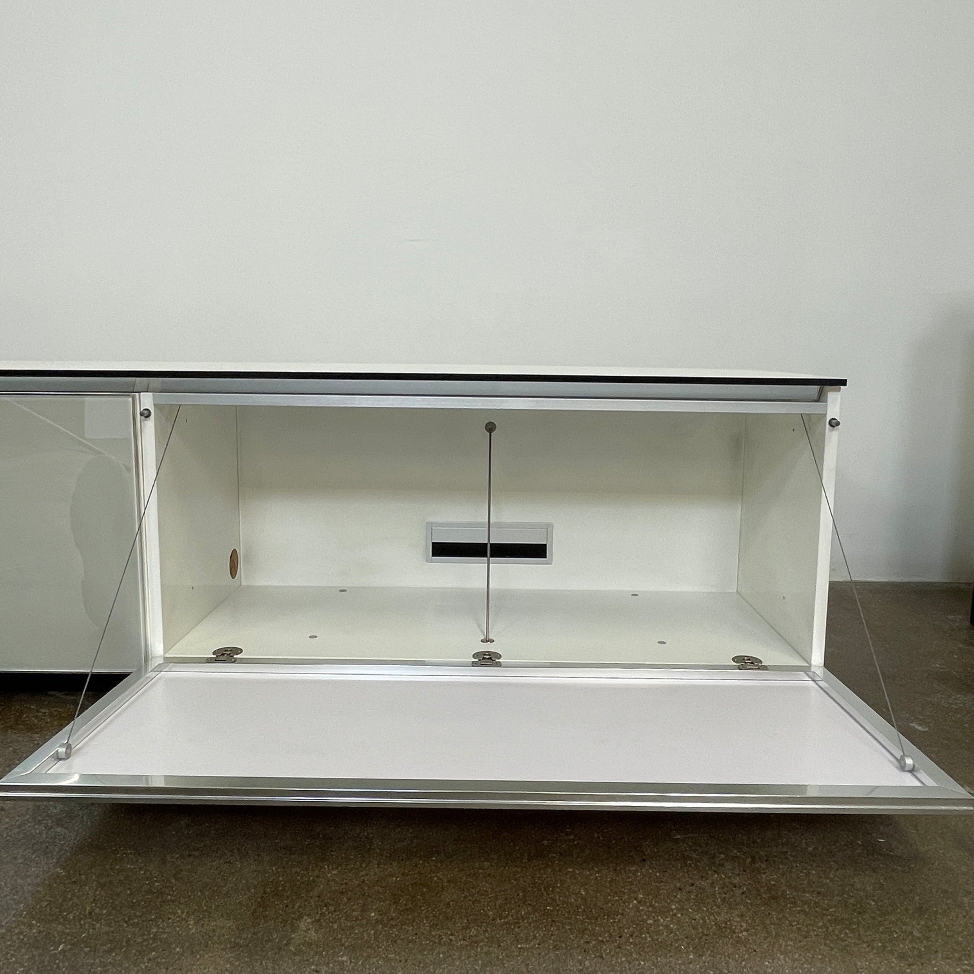 The B&B Italia Pab Low Console by B&B Italia is a rectangular, low-profile media console with glossy pearl white doors and two doors, perfect for stylish storage, shown against a plain white background.