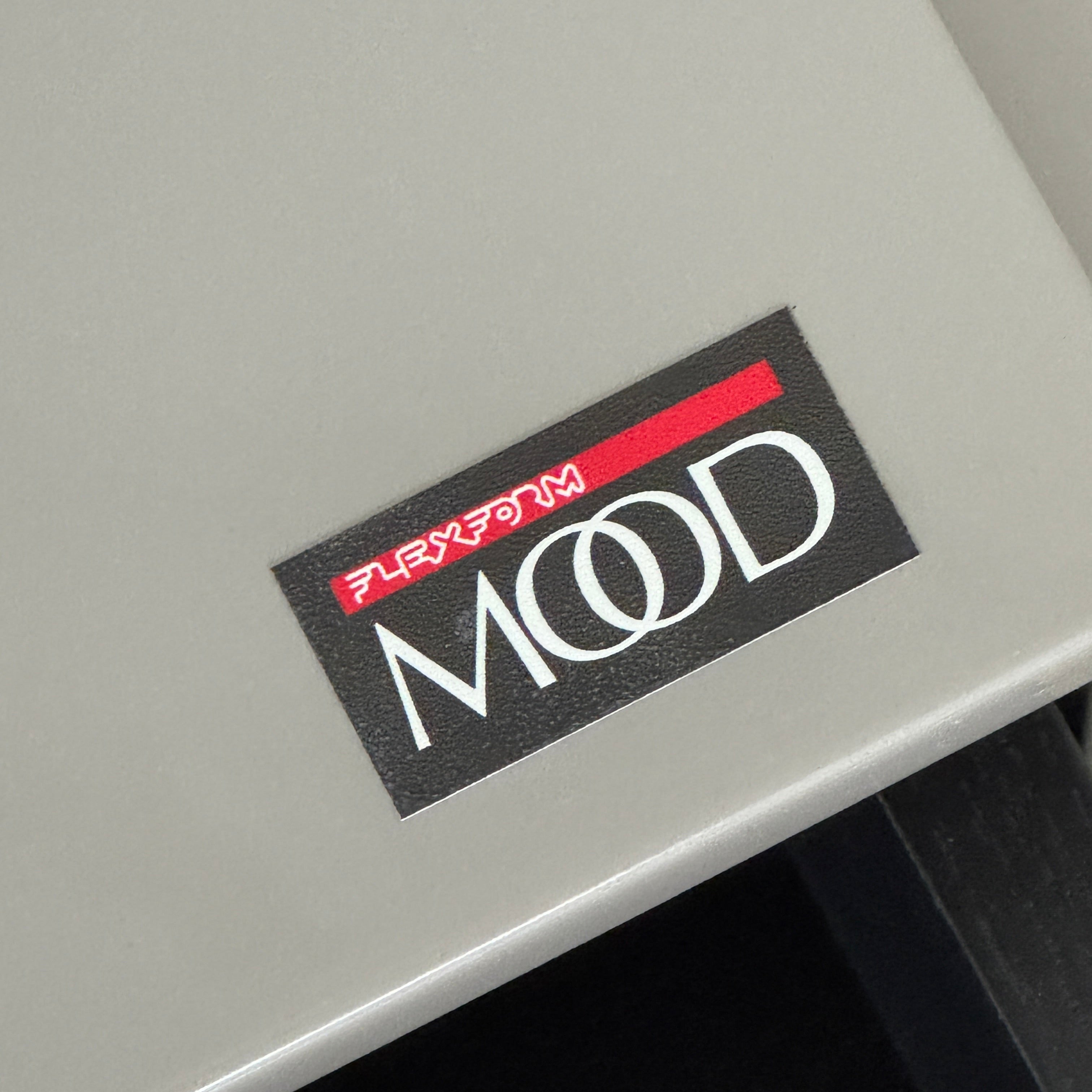 A Rev-A-Shelf instruction sheet and a "100% Thought&Made in Italy" leaflet sit on two beige trays, ideal for organizing your workspace or pairing with the Flexform Benjamin Chest of Drawers With File Insert.