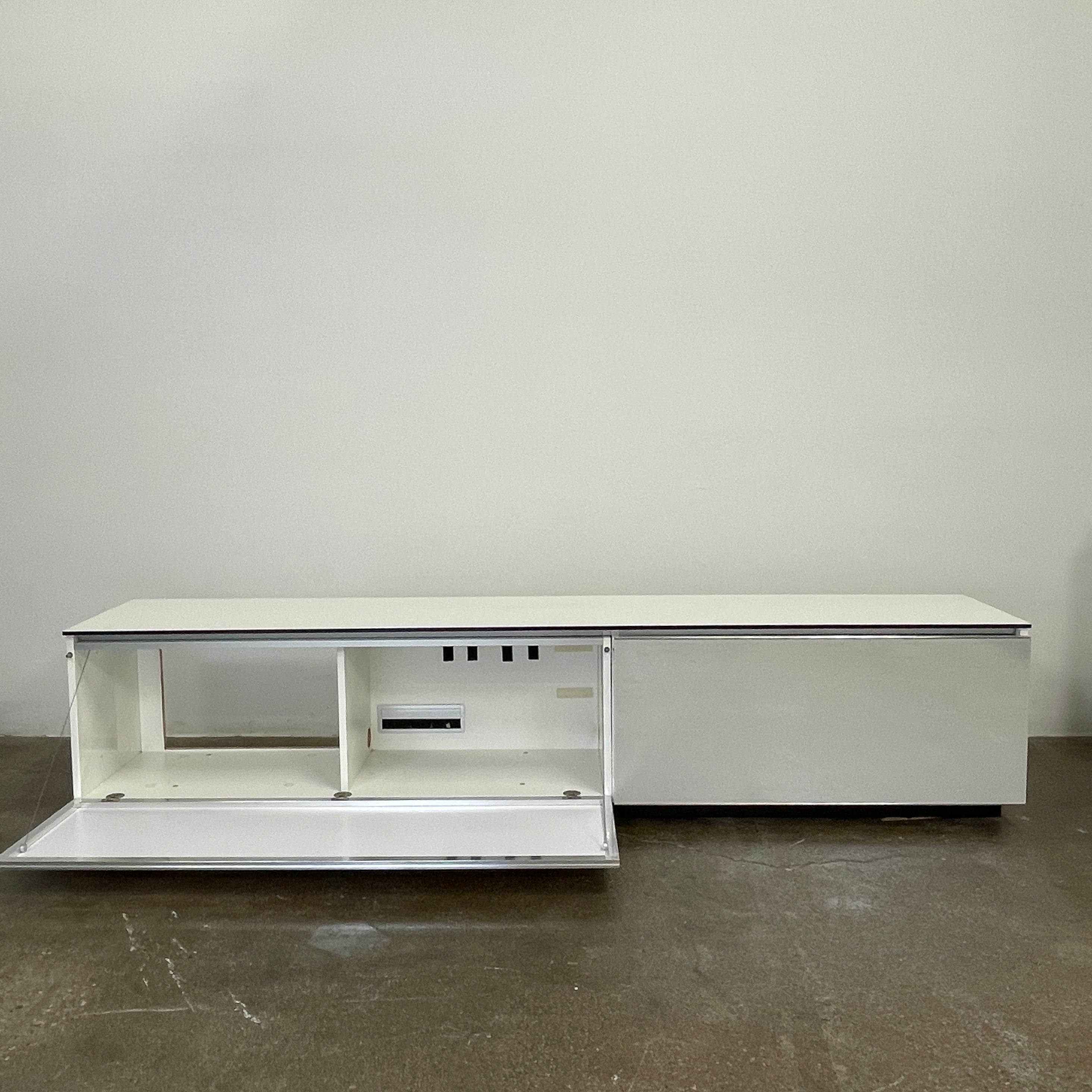 The B&B Italia Pab Low Console by B&B Italia is a rectangular, low-profile media console with glossy pearl white doors and two doors, perfect for stylish storage, shown against a plain white background.