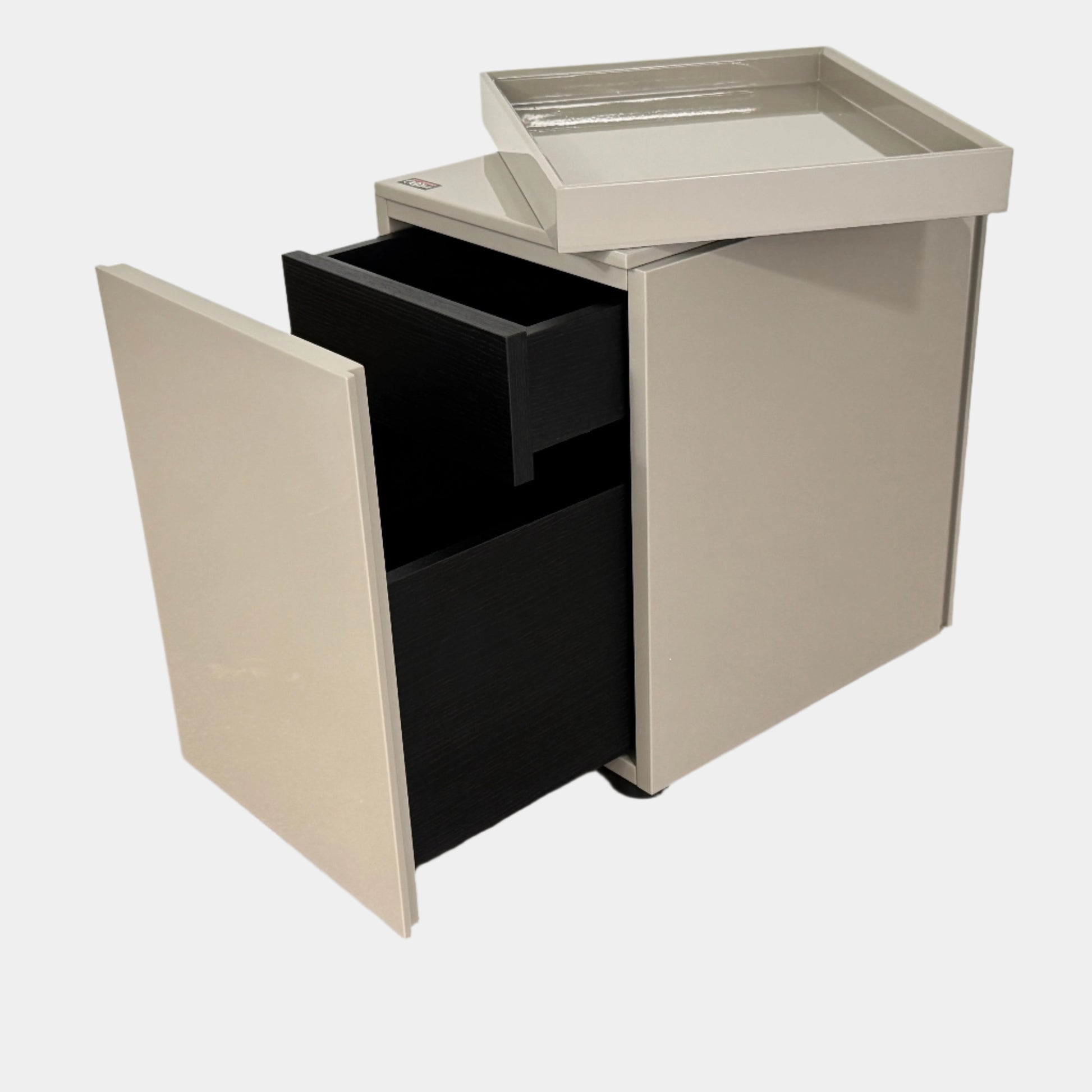A Rev-A-Shelf instruction sheet and a "100% Thought&Made in Italy" leaflet sit on two beige trays, ideal for organizing your workspace or pairing with the Flexform Benjamin Chest of Drawers With File Insert.