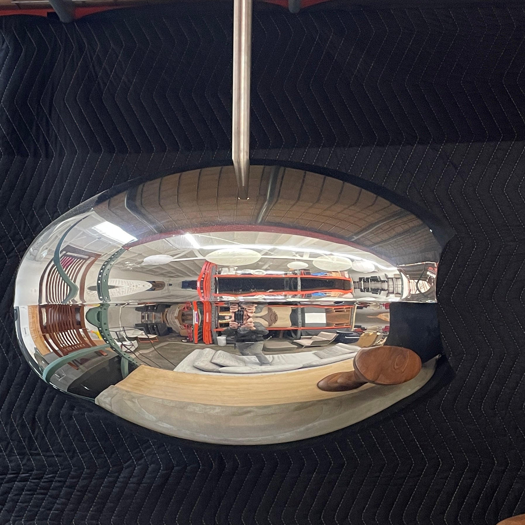 The Plushpod Cocoon Hanging Fireplace is a modern marvel with its oval design, sleek metallic finish, and reflective surface. Its rectangular opening radiates warmth and adds style to any space.