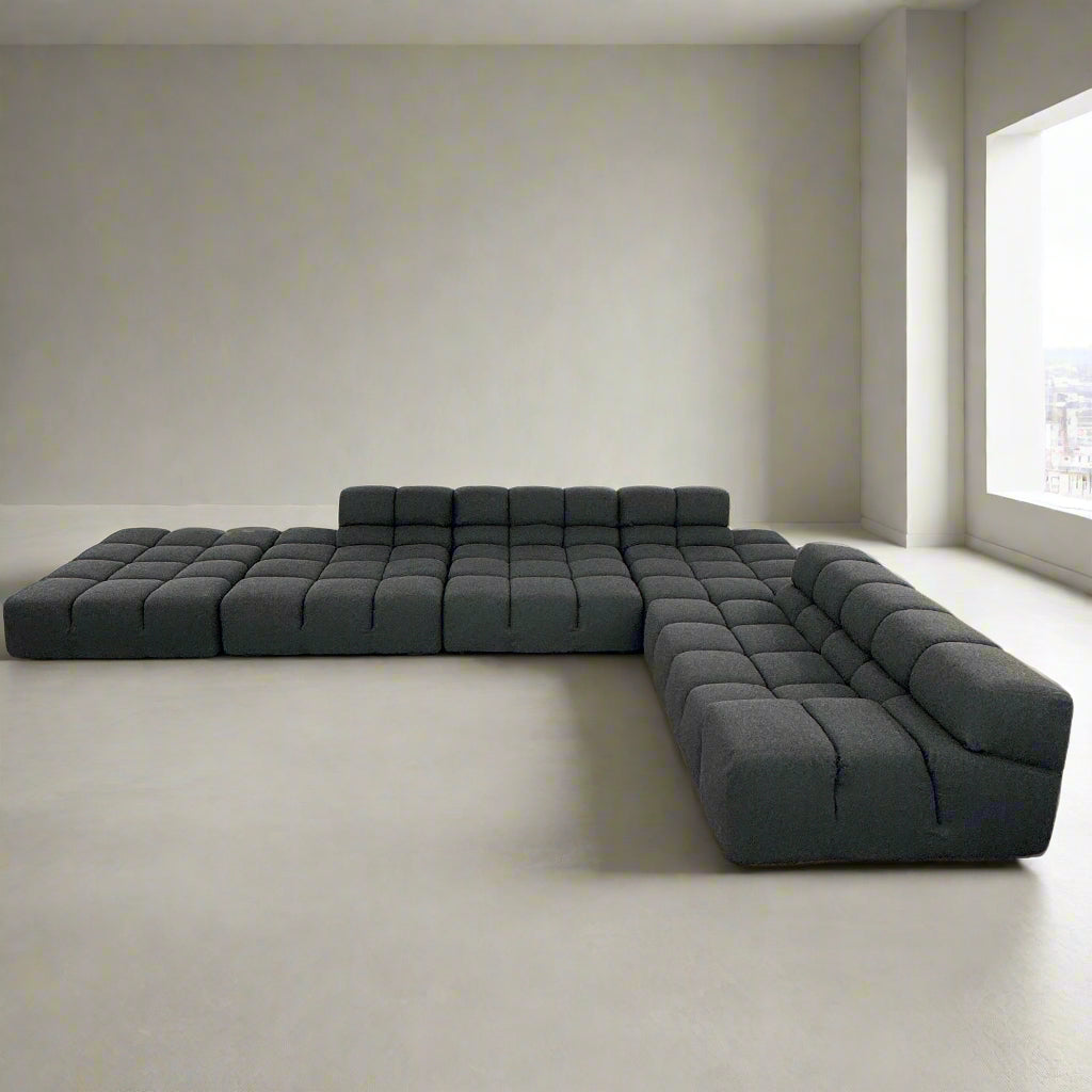 A B&B Italia 5 Piece Tufty Time Sectional with tufted cushions sits in an L-shape on a polished concrete floor against a plain white wall.