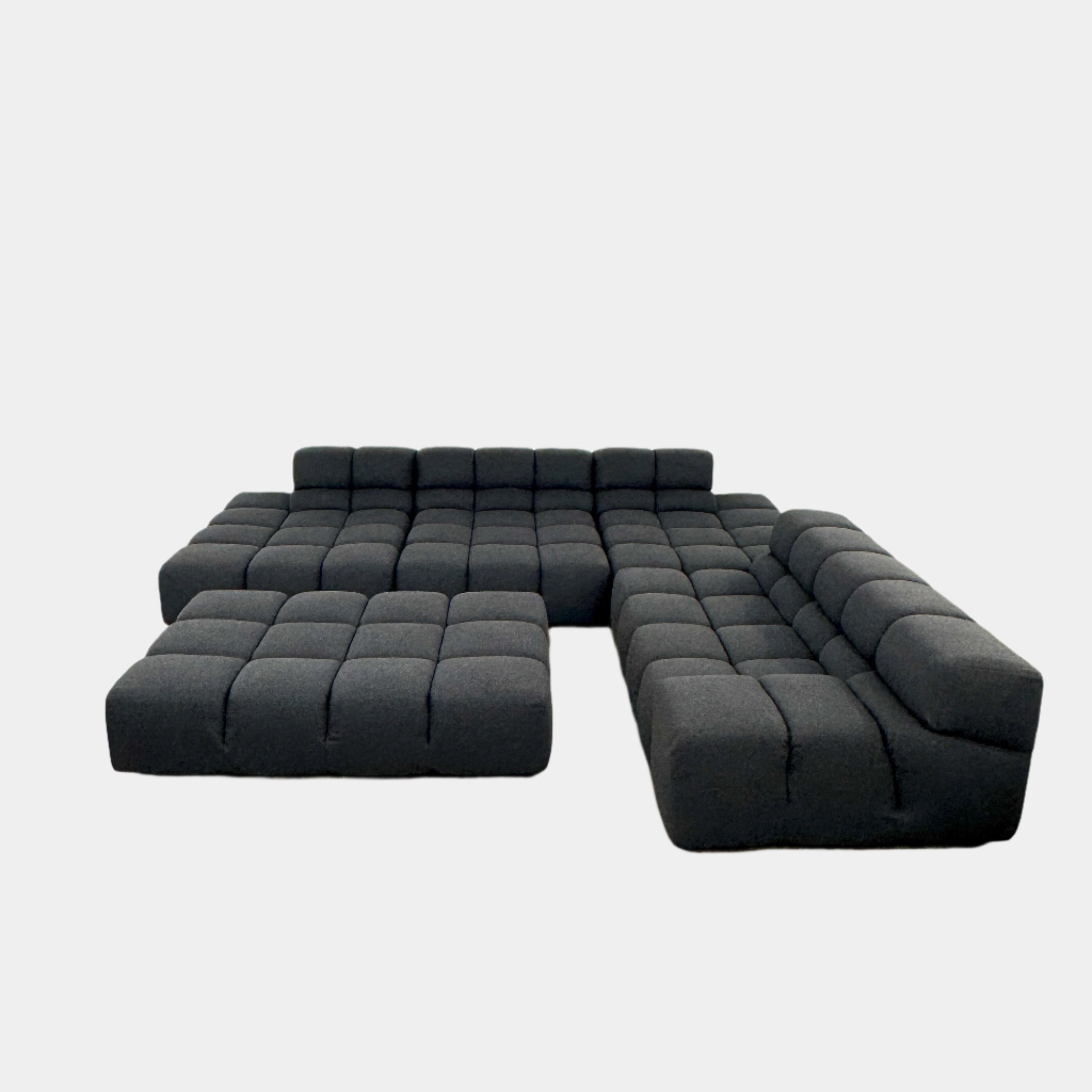 A B&B Italia 5 Piece Tufty Time Sectional with tufted cushions sits in an L-shape on a polished concrete floor against a plain white wall.