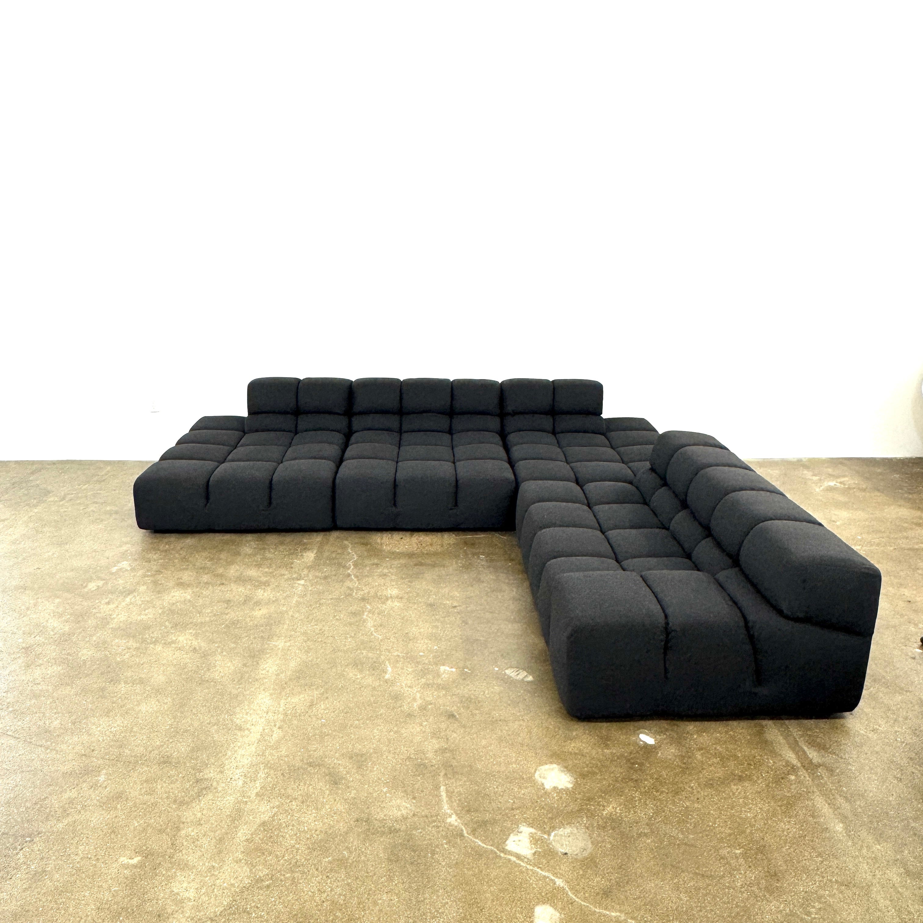 A B&B Italia 5 Piece Tufty Time Sectional with tufted cushions sits in an L-shape on a polished concrete floor against a plain white wall.