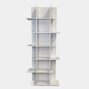 The Ligne Roset Everywhere Bookcase by Ligne Roset is a tall, modern white bookshelf with staggered geometric shelves.