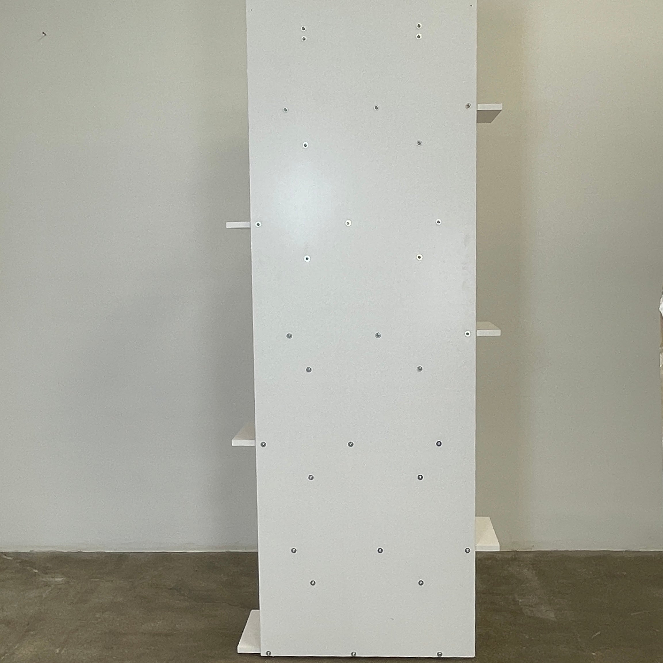 The Ligne Roset Everywhere Bookcase by Ligne Roset is a tall, modern white bookshelf with staggered geometric shelves.