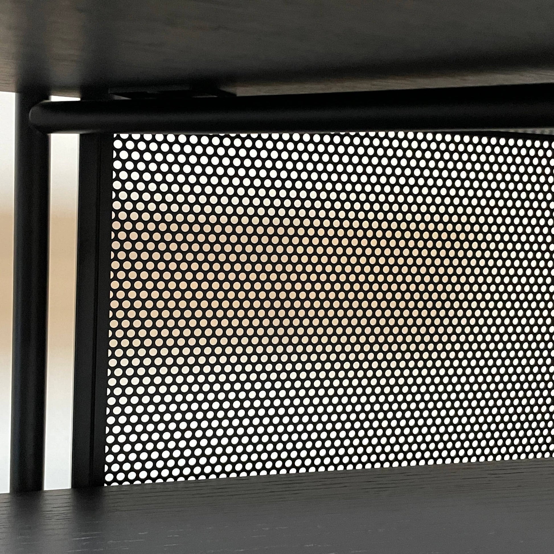 A Ligne Roset Clyde Bookcase with a mesh back.