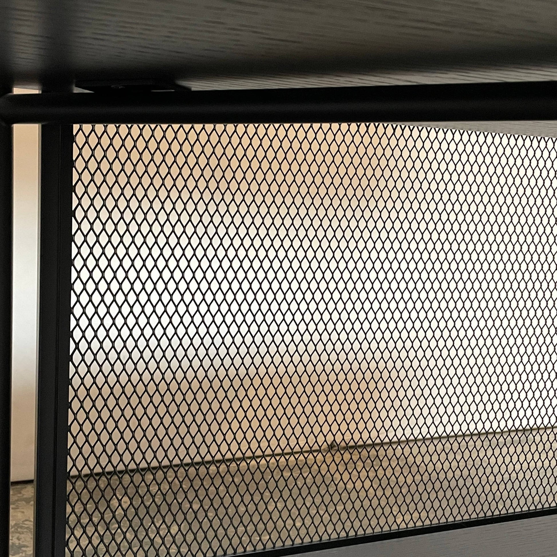 A Ligne Roset Clyde Bookcase with a mesh back.