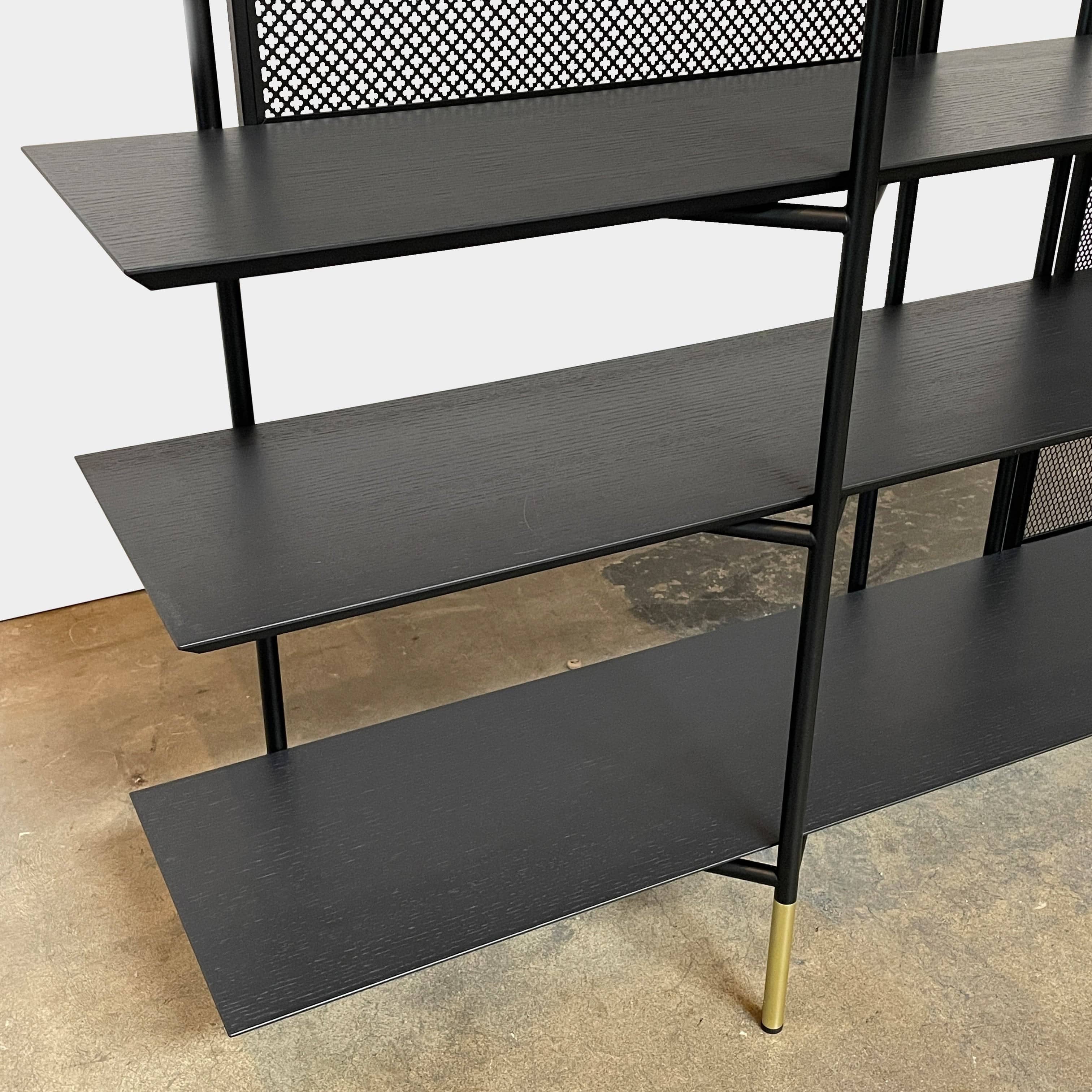 A Ligne Roset Clyde Bookcase with a mesh back.