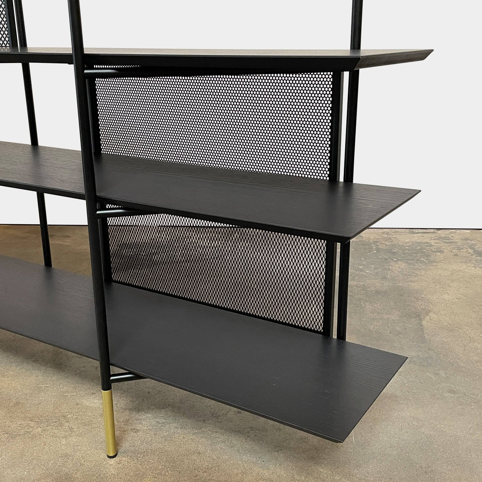 A Ligne Roset Clyde Bookcase with a mesh back.
