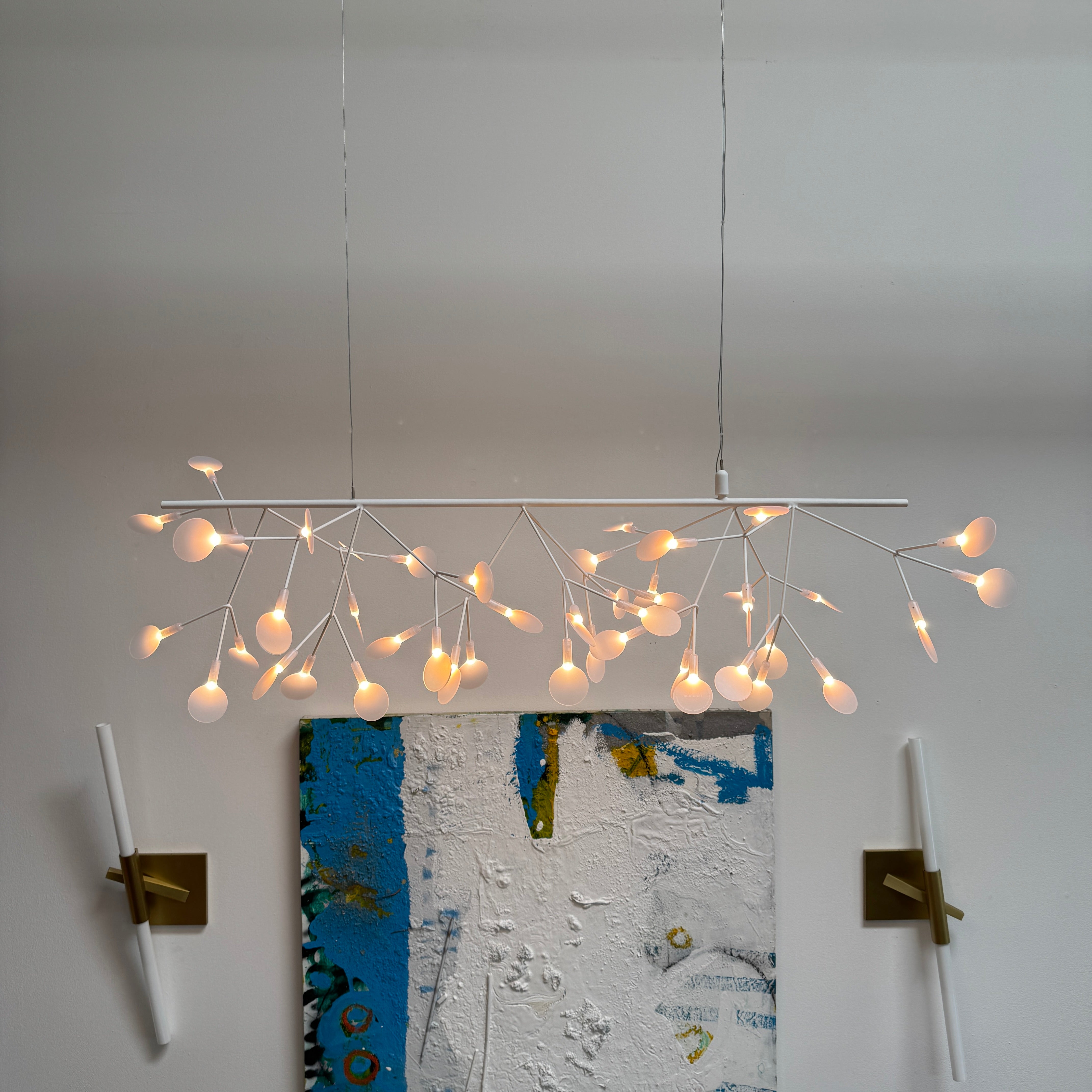 The Moooi Heracleum Endless LED Suspension Lamp-White is a modern chandelier featuring multiple radial branches ending in circular light diffusers, hanging from a single cord attached to a round ceiling mount.
