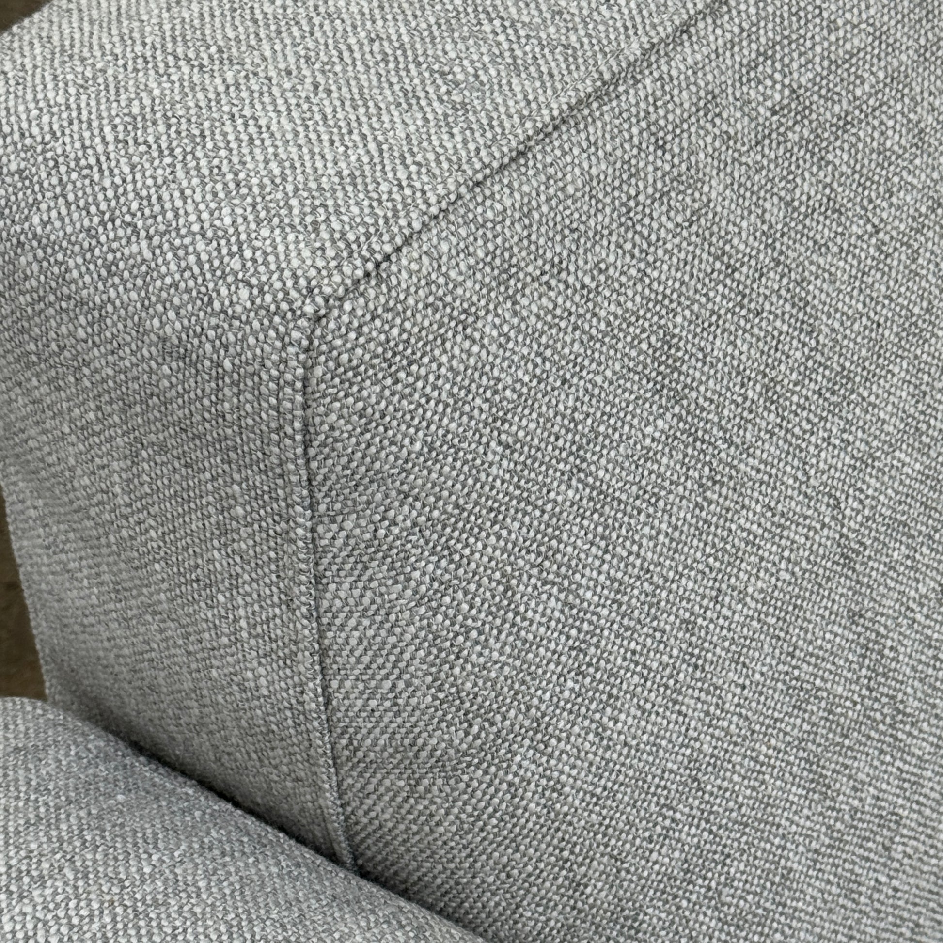 A contemporary Flexform Dream Sofa in light gray, featuring wide armrests and black metal legs, is displayed against a plain white background.