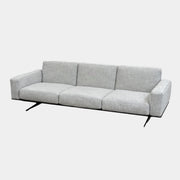 A contemporary Flexform Dream Sofa in light gray, featuring wide armrests and black metal legs, is displayed against a plain white background.