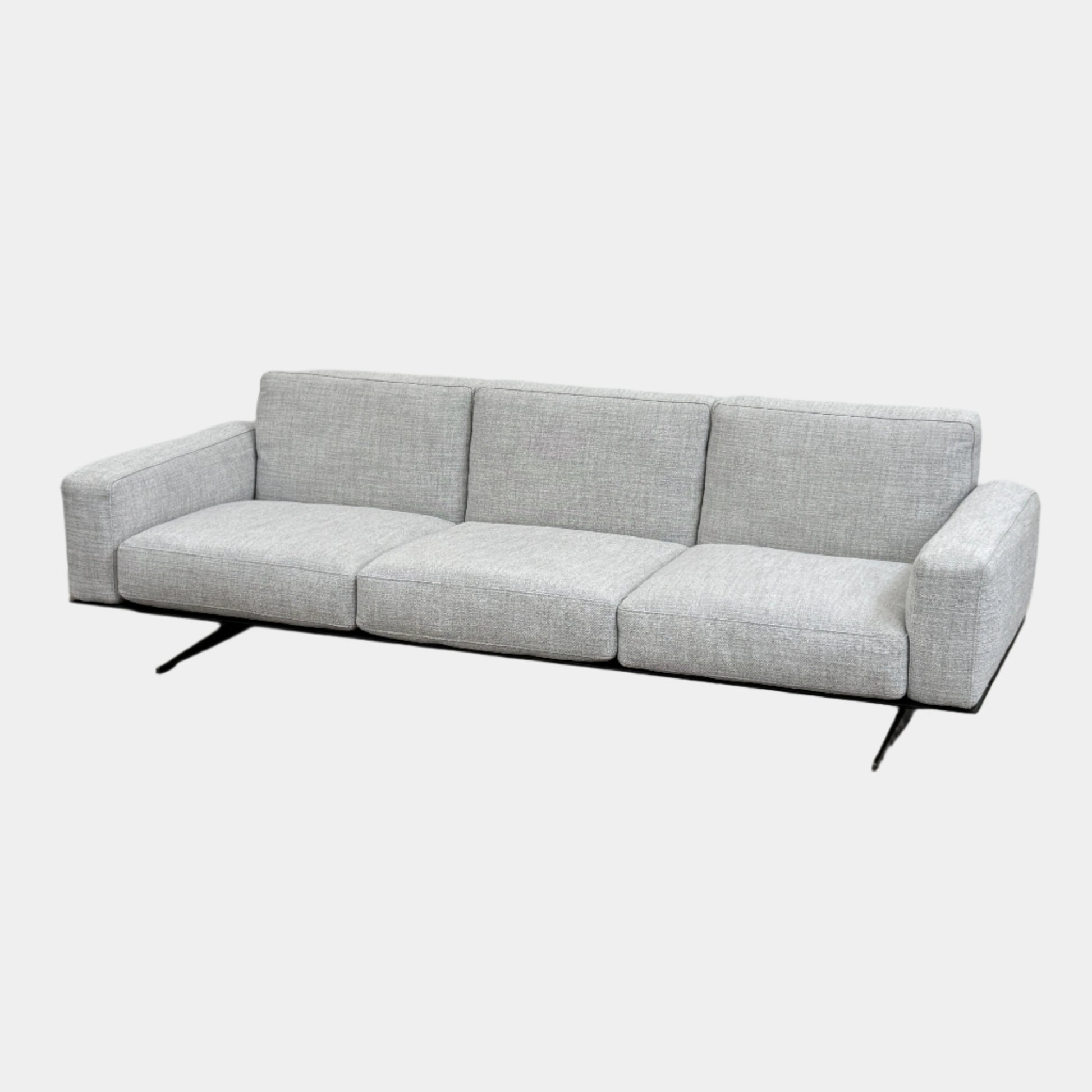 A contemporary Flexform Dream Sofa in light gray, featuring wide armrests and black metal legs, is displayed against a plain white background.