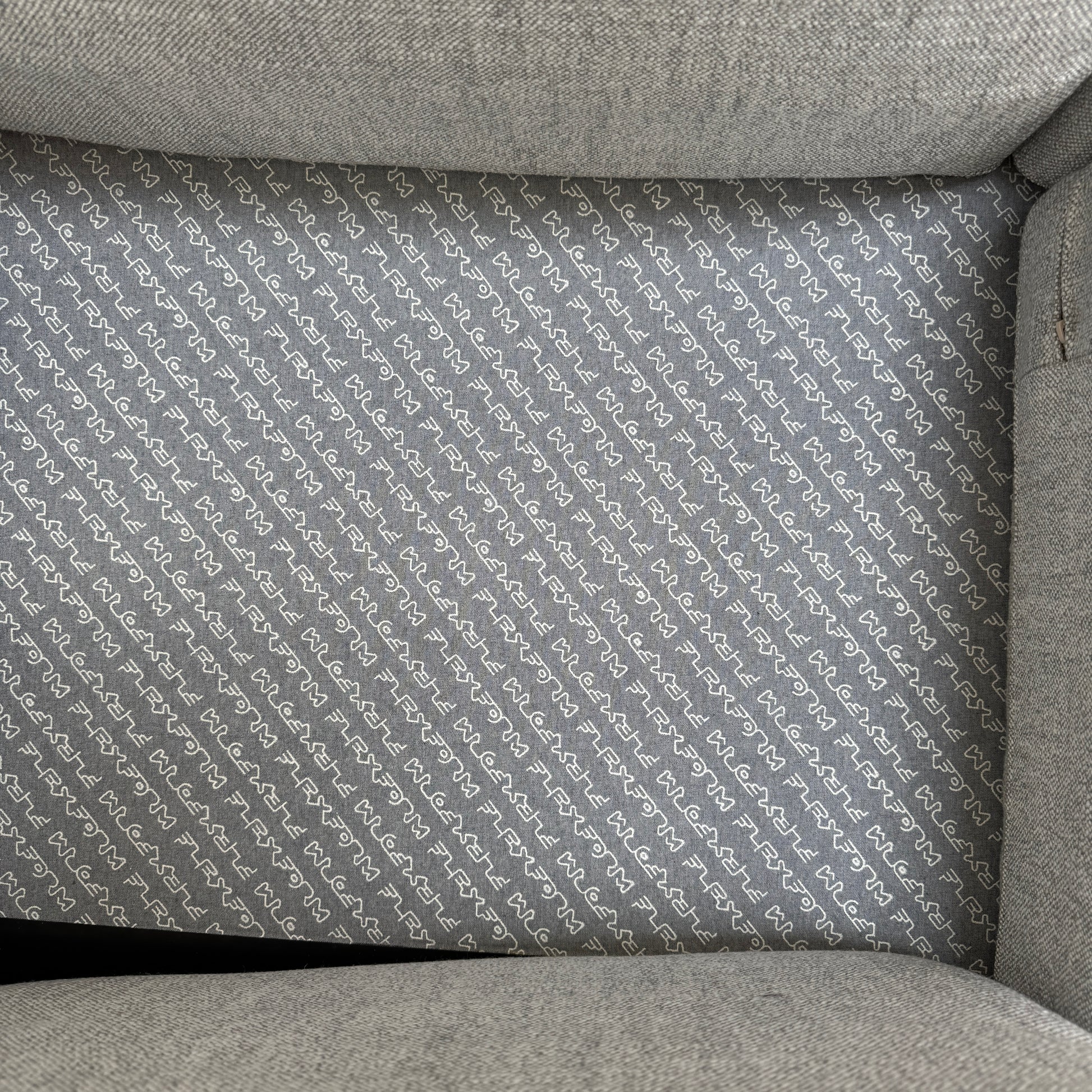 A contemporary Flexform Dream Sofa in light gray, featuring wide armrests and black metal legs, is displayed against a plain white background.