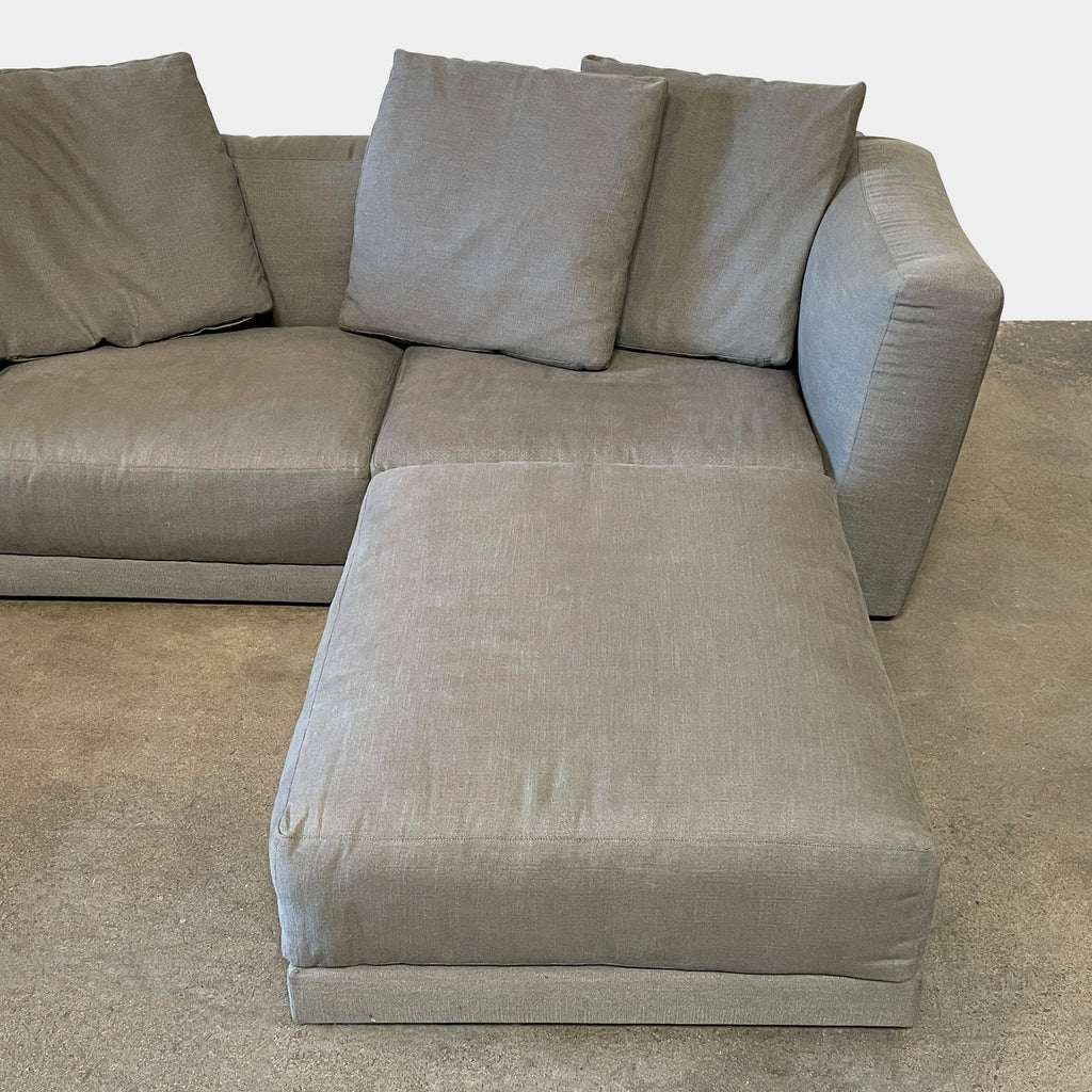 The B&B Italia Luis Sofa & Ottoman, accompanied by a matching ottoman, stands out against a crisp white background.