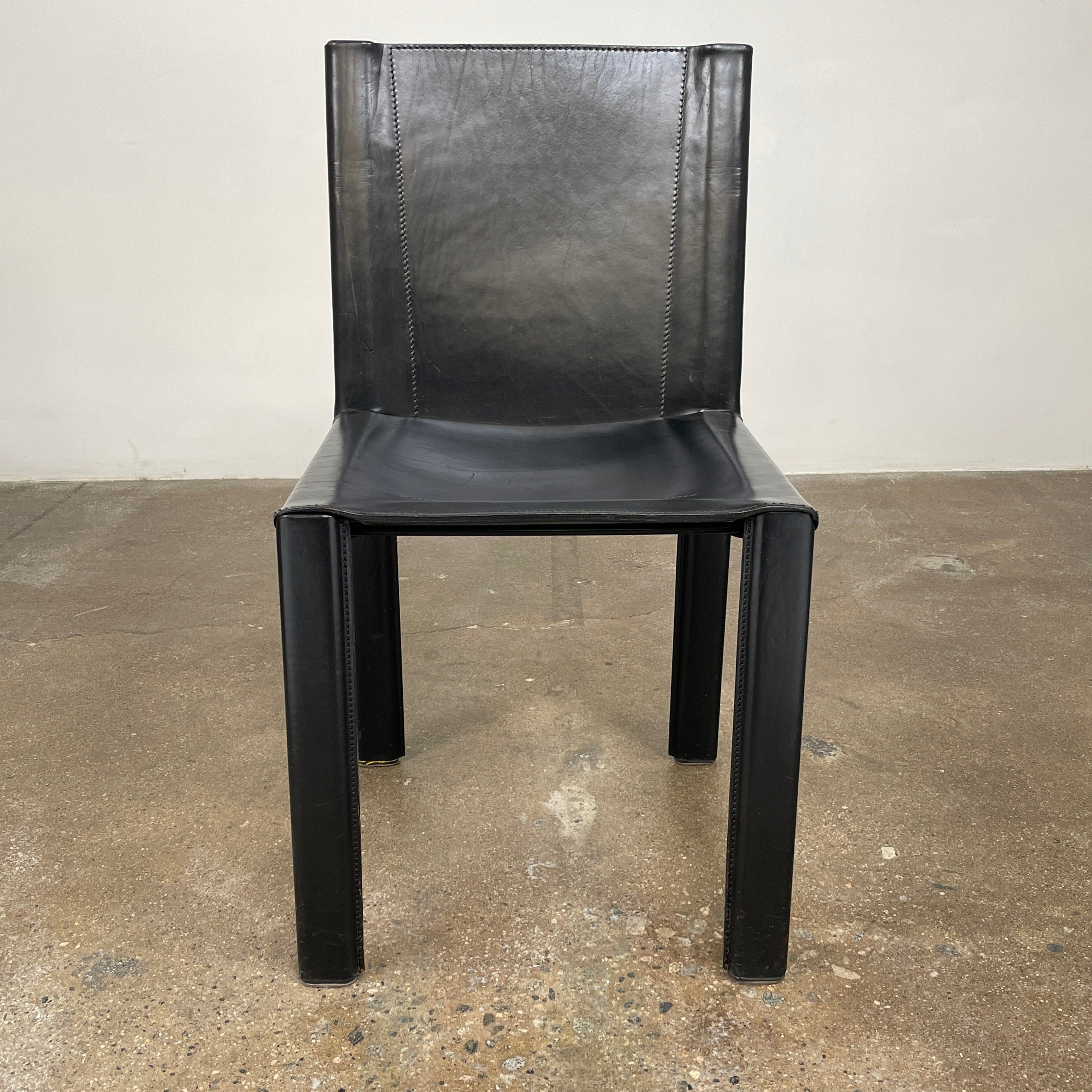 Eight Vintage Matteo Grassi 'Coral' dining chairs, showcasing a sleek black finish, are arranged in two rows on a pristine white background.