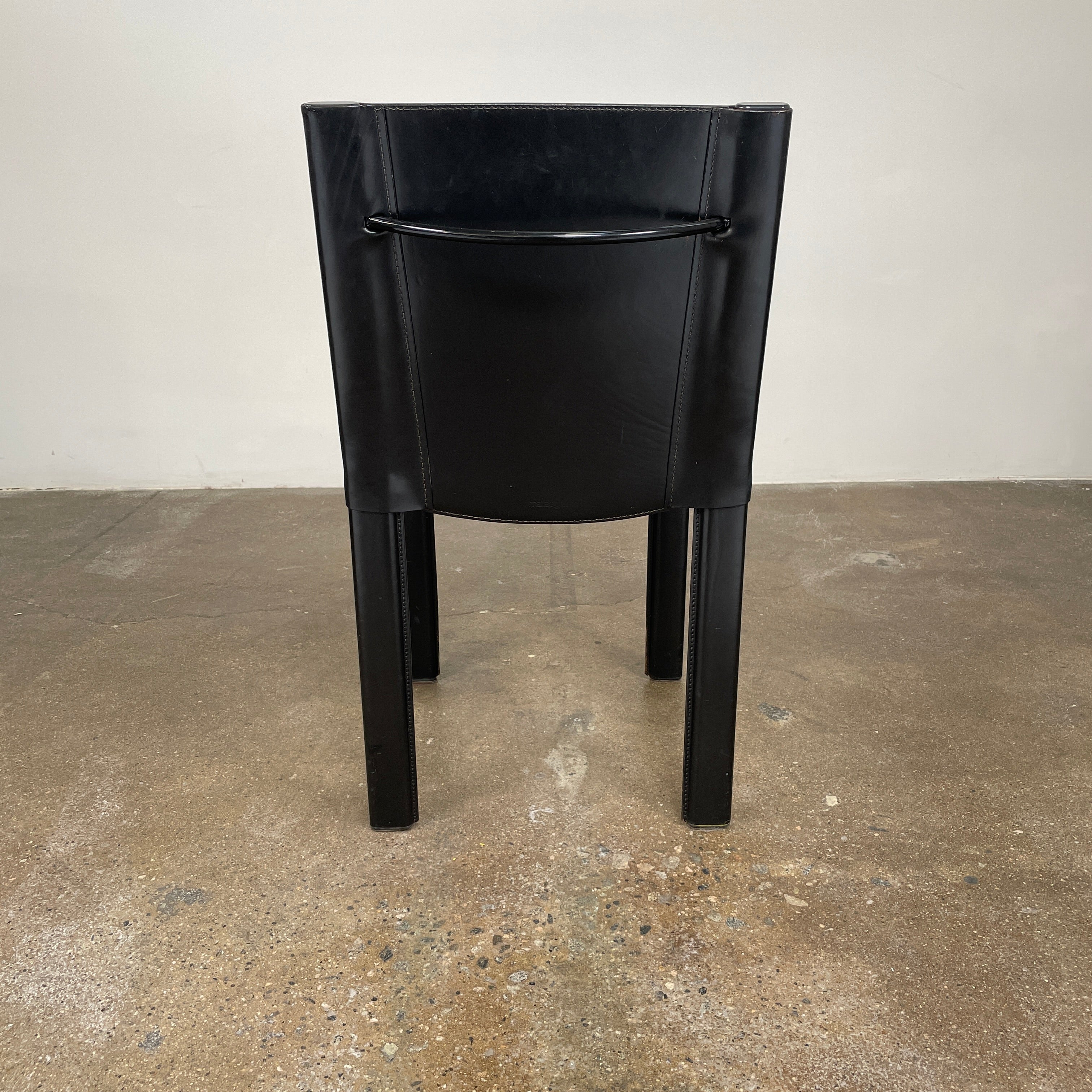 Eight Vintage Matteo Grassi 'Coral' dining chairs, showcasing a sleek black finish, are arranged in two rows on a pristine white background.