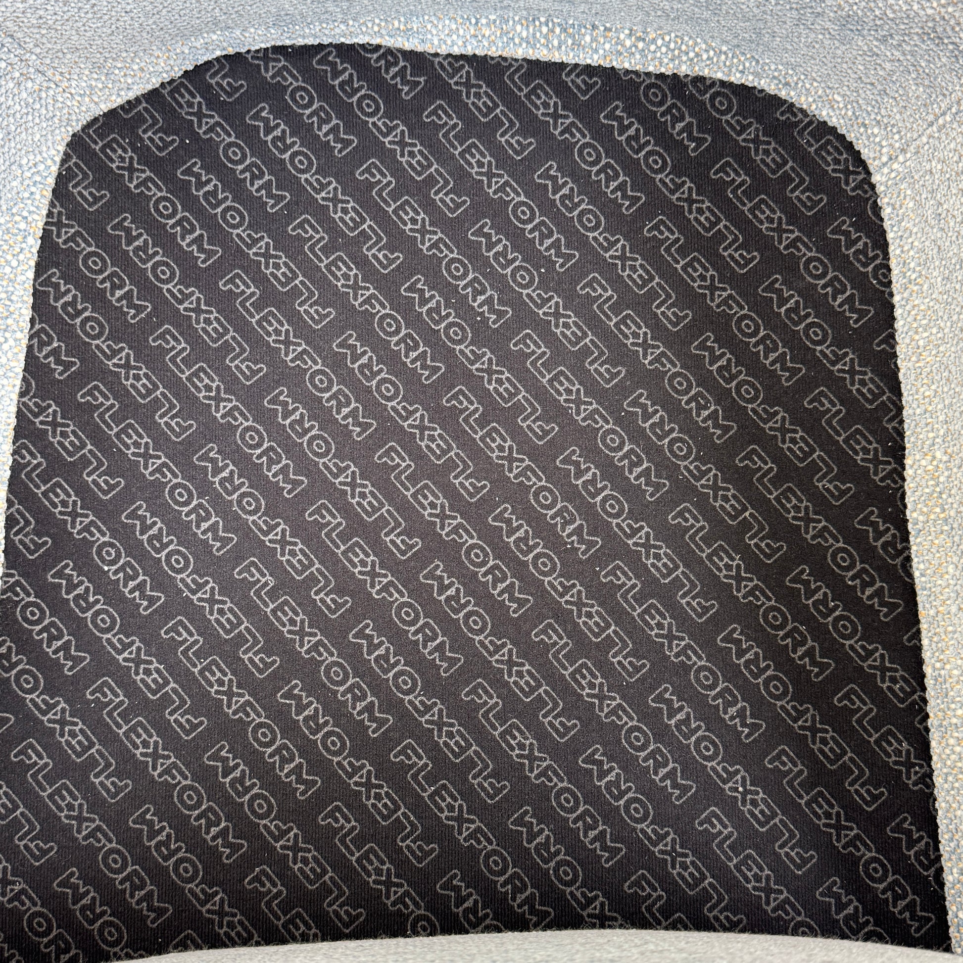 The Flexform Marlon Swivel Armchair and Ottoman, available with two covers, feature ergonomic design and black metal bases from Flexform, shown here in a modern gray finish against a plain white background.