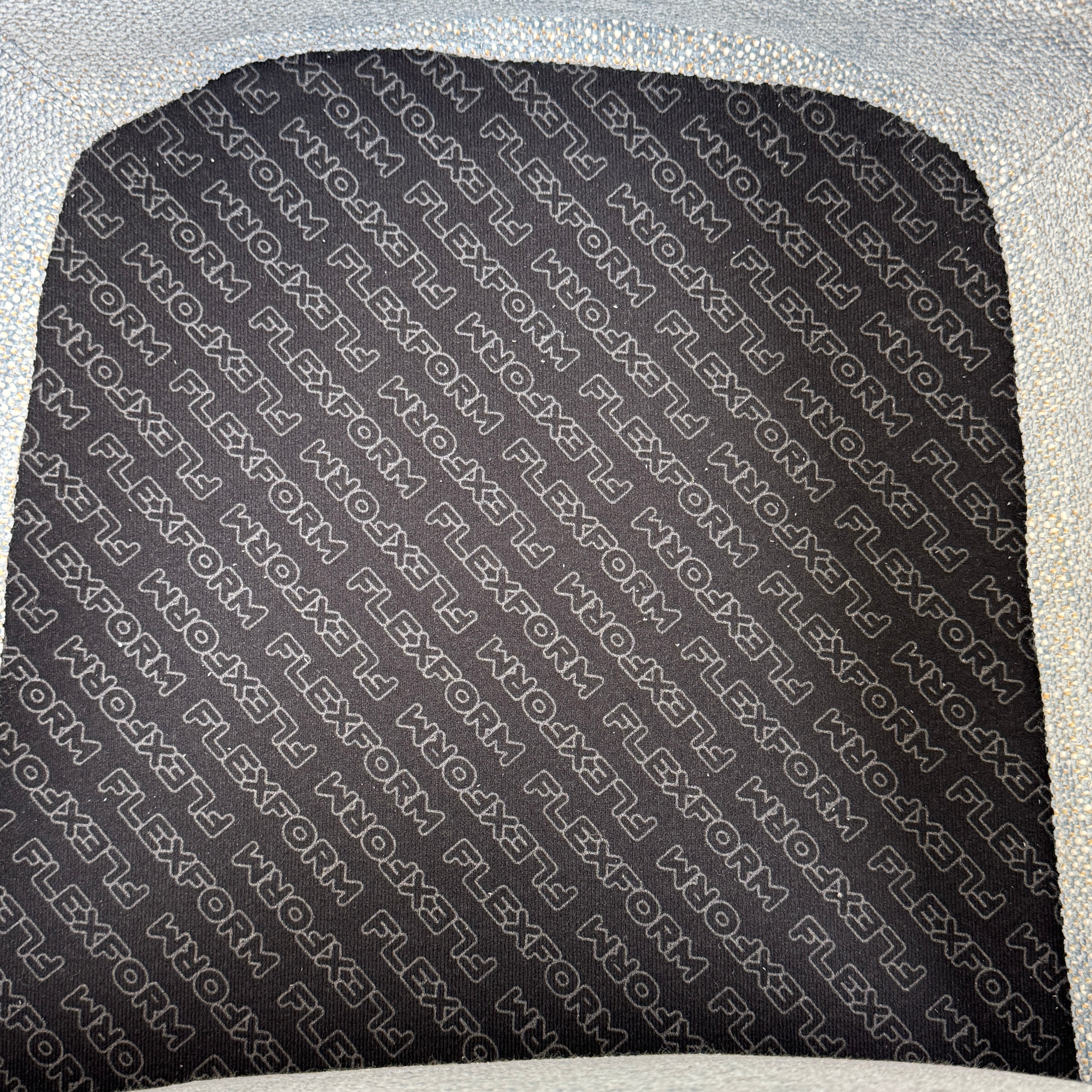 The Flexform Marlon Swivel Armchair and Ottoman, available with two covers, feature ergonomic design and black metal bases from Flexform, shown here in a modern gray finish against a plain white background.