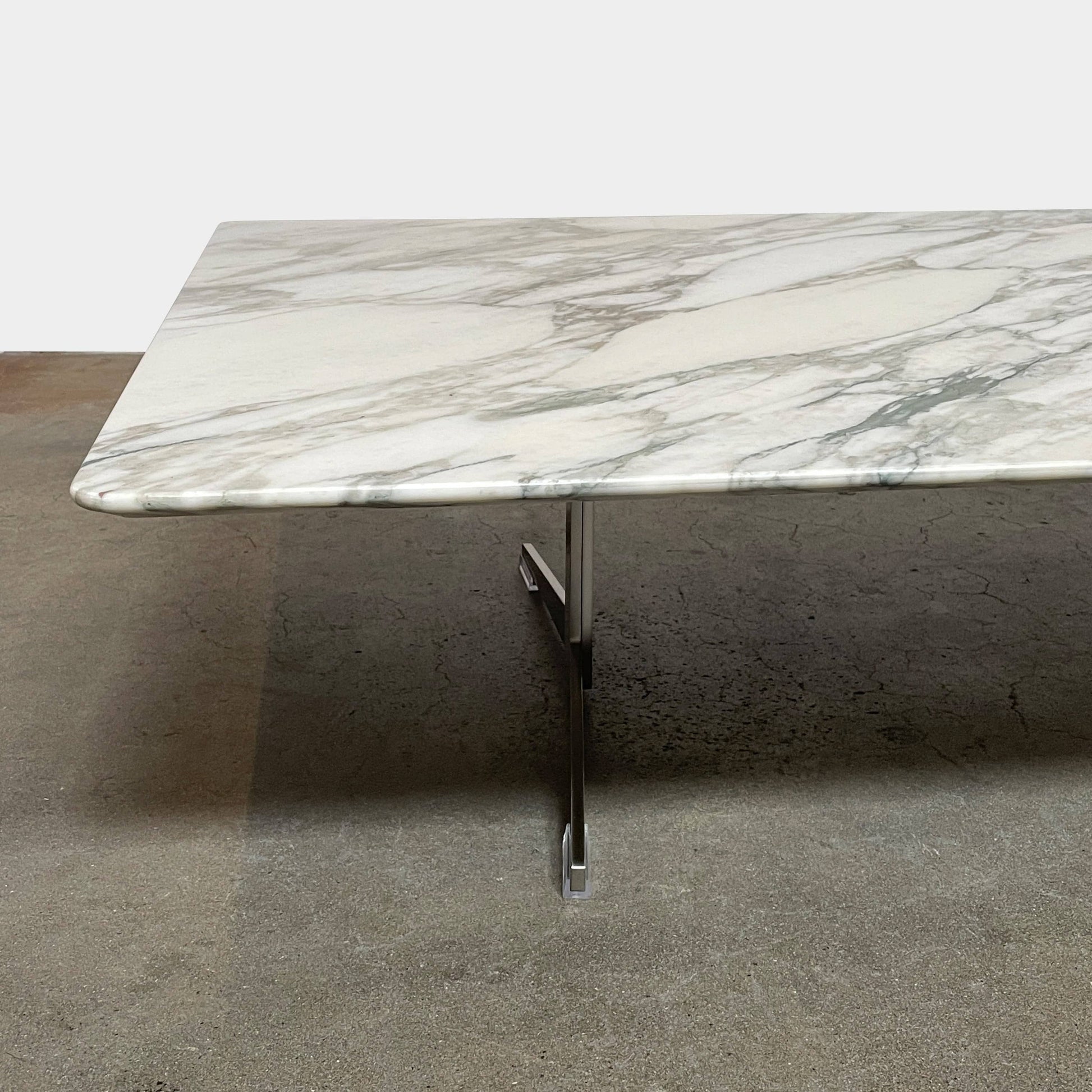 A Flexform Fly Marble Coffee Table with black legs on a white background.