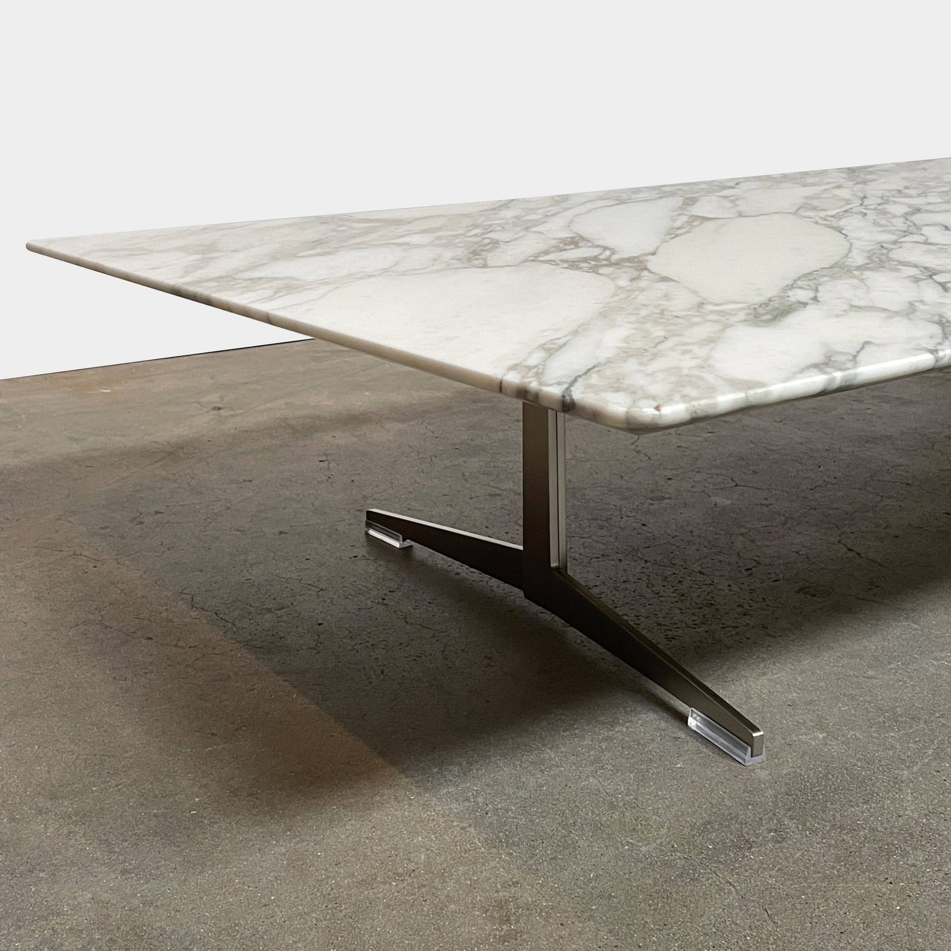 A Flexform Fly Marble Coffee Table with black legs on a white background.