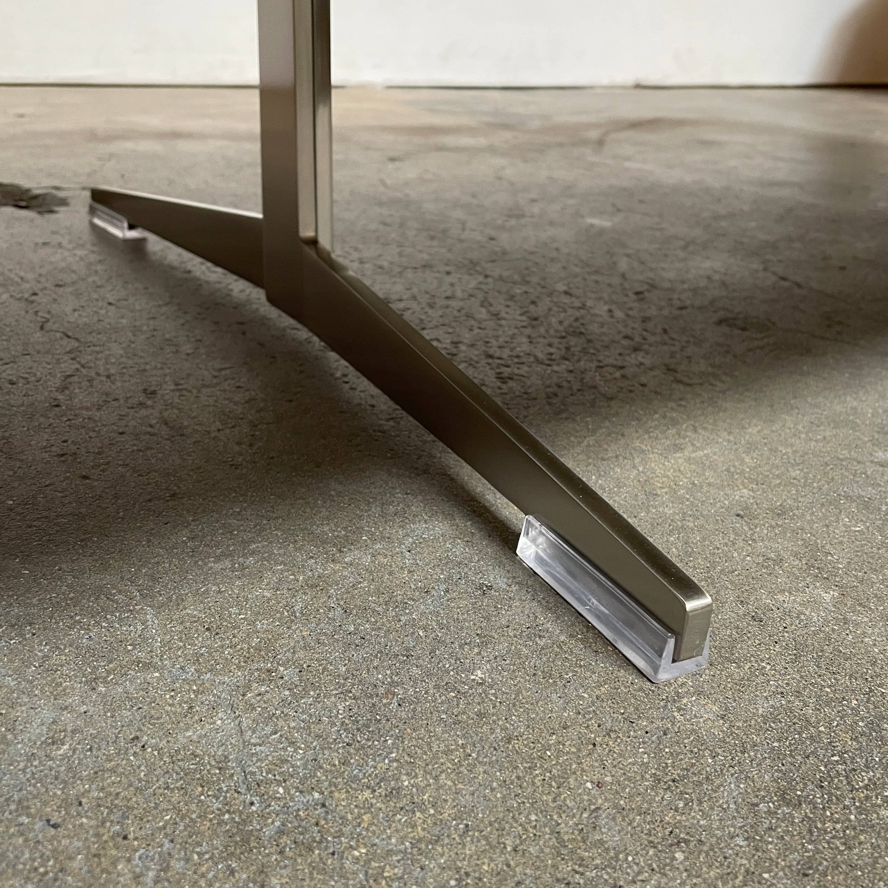 A Flexform Fly Marble Coffee Table with black legs on a white background.