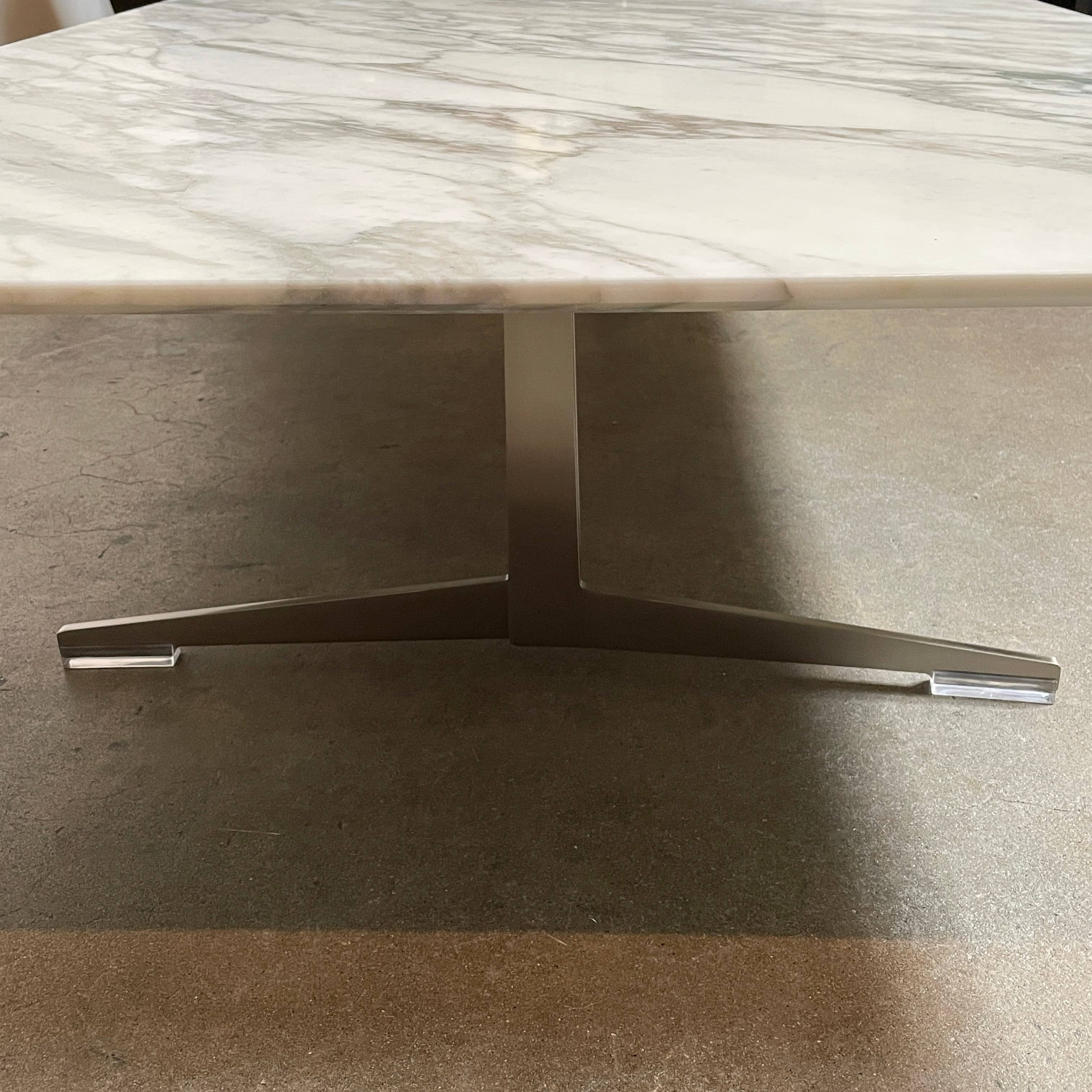 A Flexform Fly Marble Coffee Table with black legs on a white background.