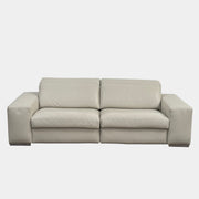 The Roche Bobois Leather Sofa With Movable Headrest features a modern beige design, wide armrests, metal legs, and an adjustable headrest—ideal for any contemporary living space.