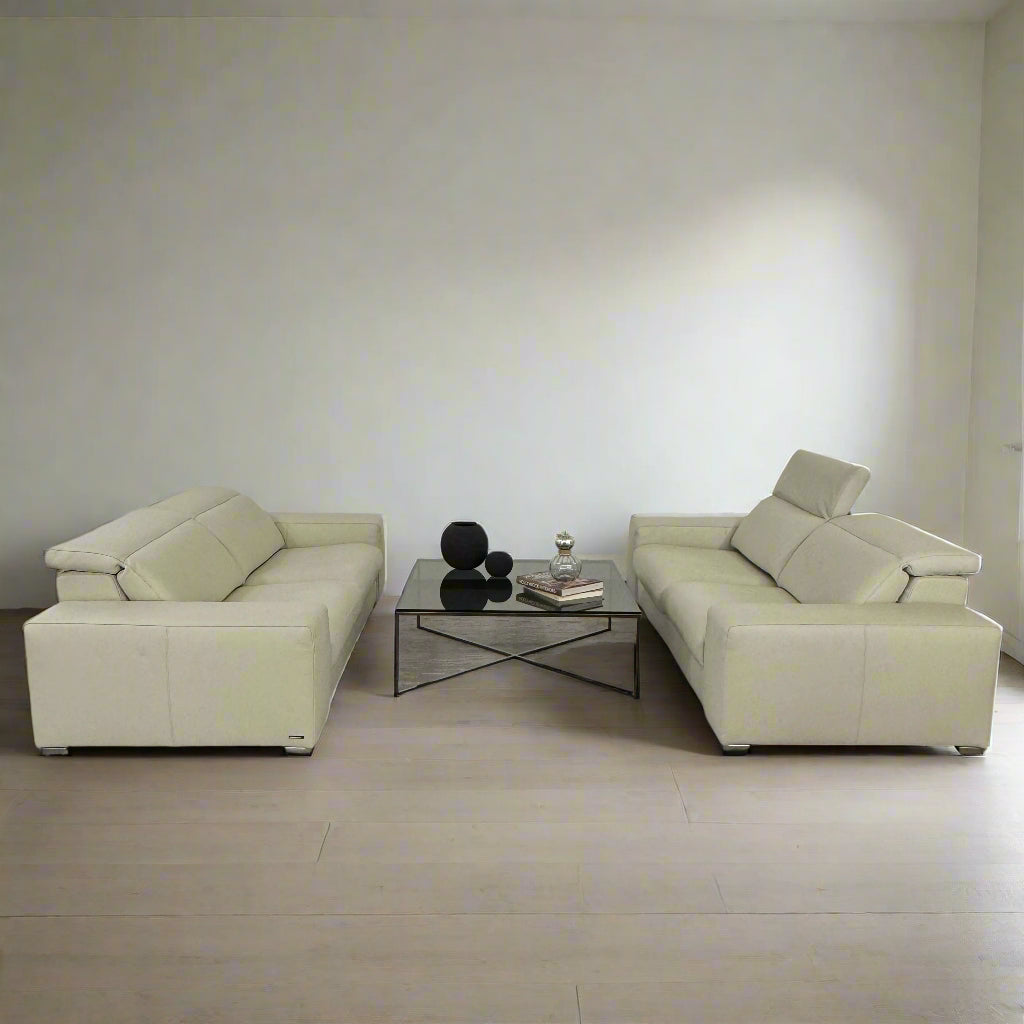 The Roche Bobois Leather Sofa With Movable Headrest features a modern beige design, wide armrests, metal legs, and an adjustable headrest—ideal for any contemporary living space.