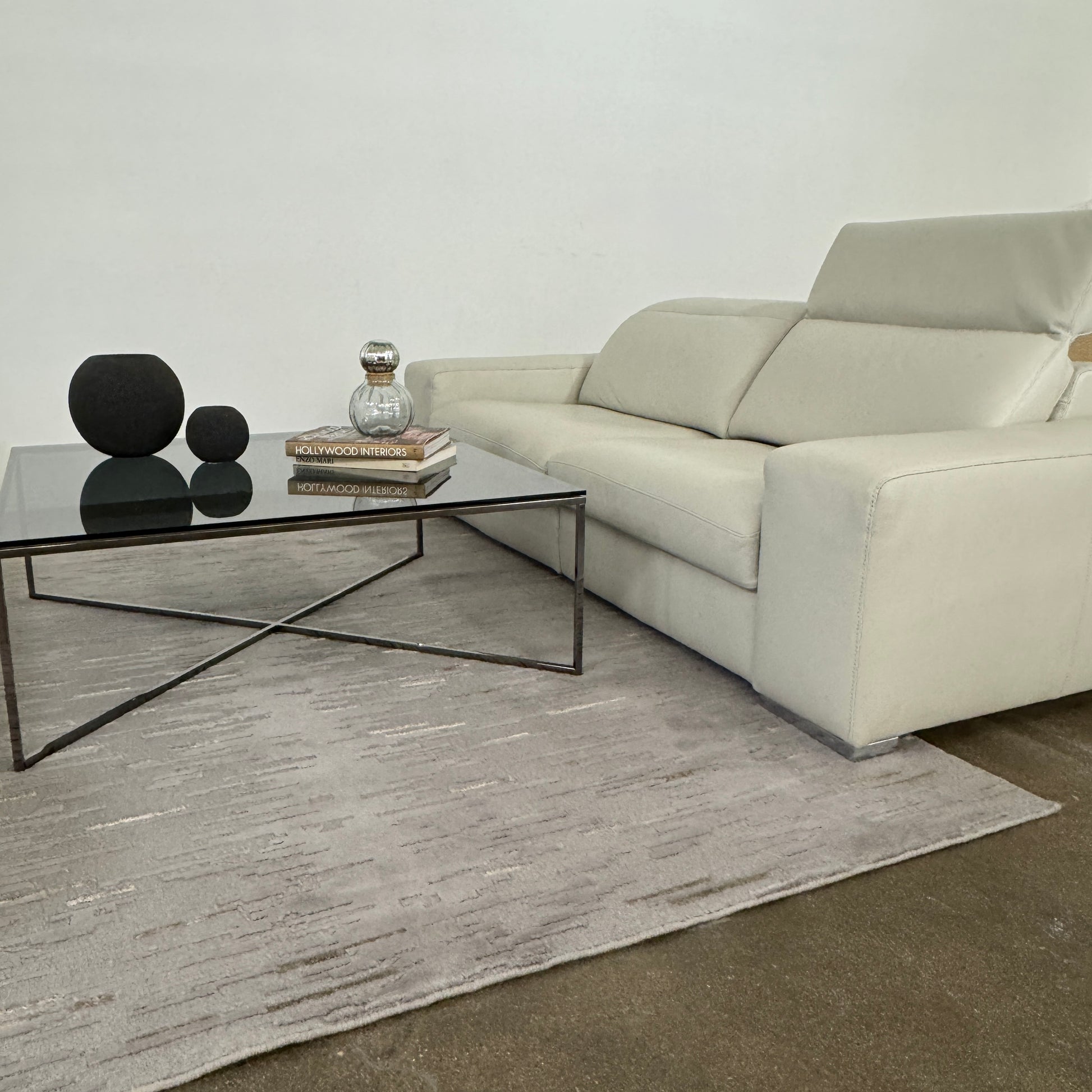 The Roche Bobois Leather Sofa With Movable Headrest features a modern beige design, wide armrests, metal legs, and an adjustable headrest—ideal for any contemporary living space.