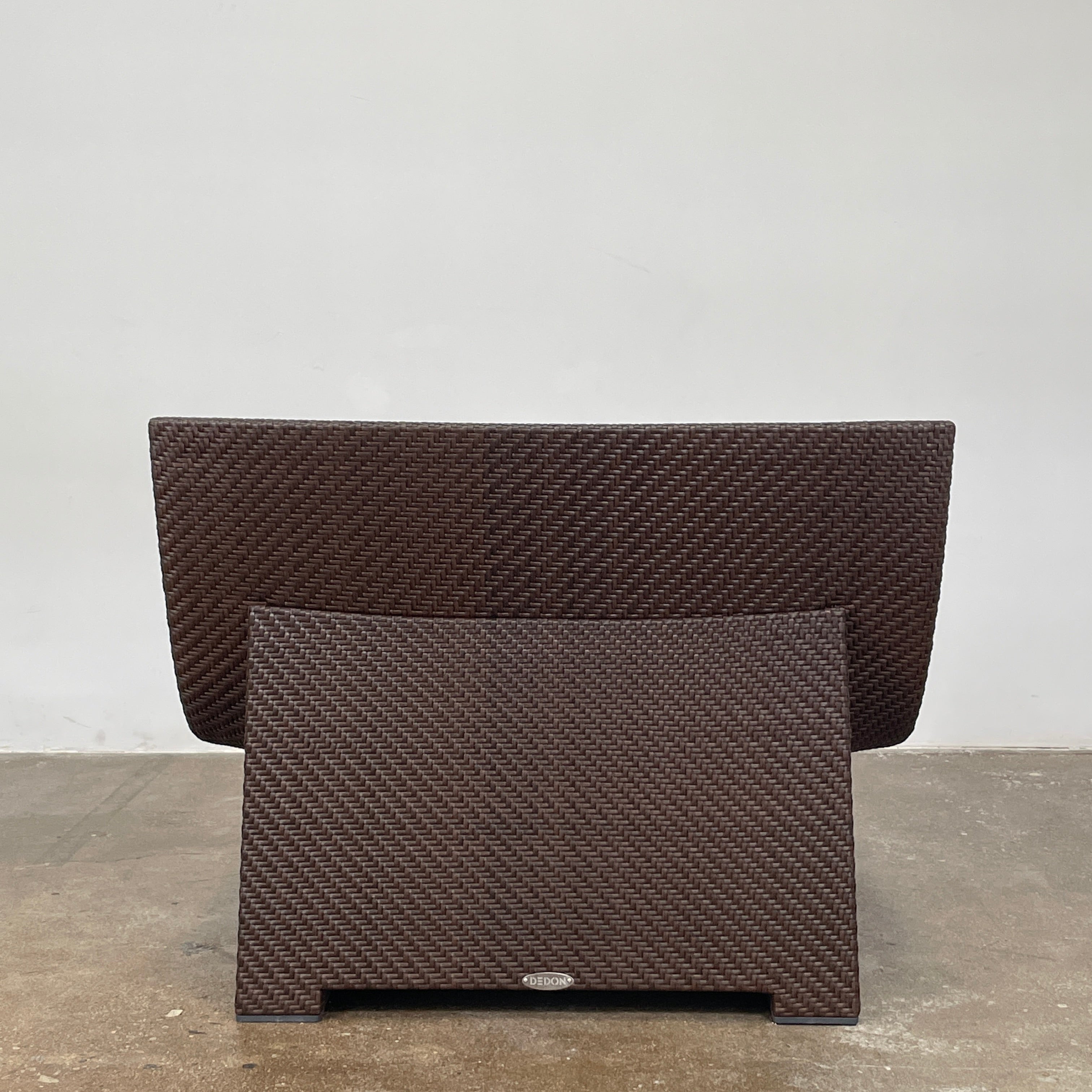 The Dedon Spa Outdoor Lounge Chairs set features two cream-cushioned seats made with proprietary fiber, beautifully displayed side by side against a simple white backdrop.