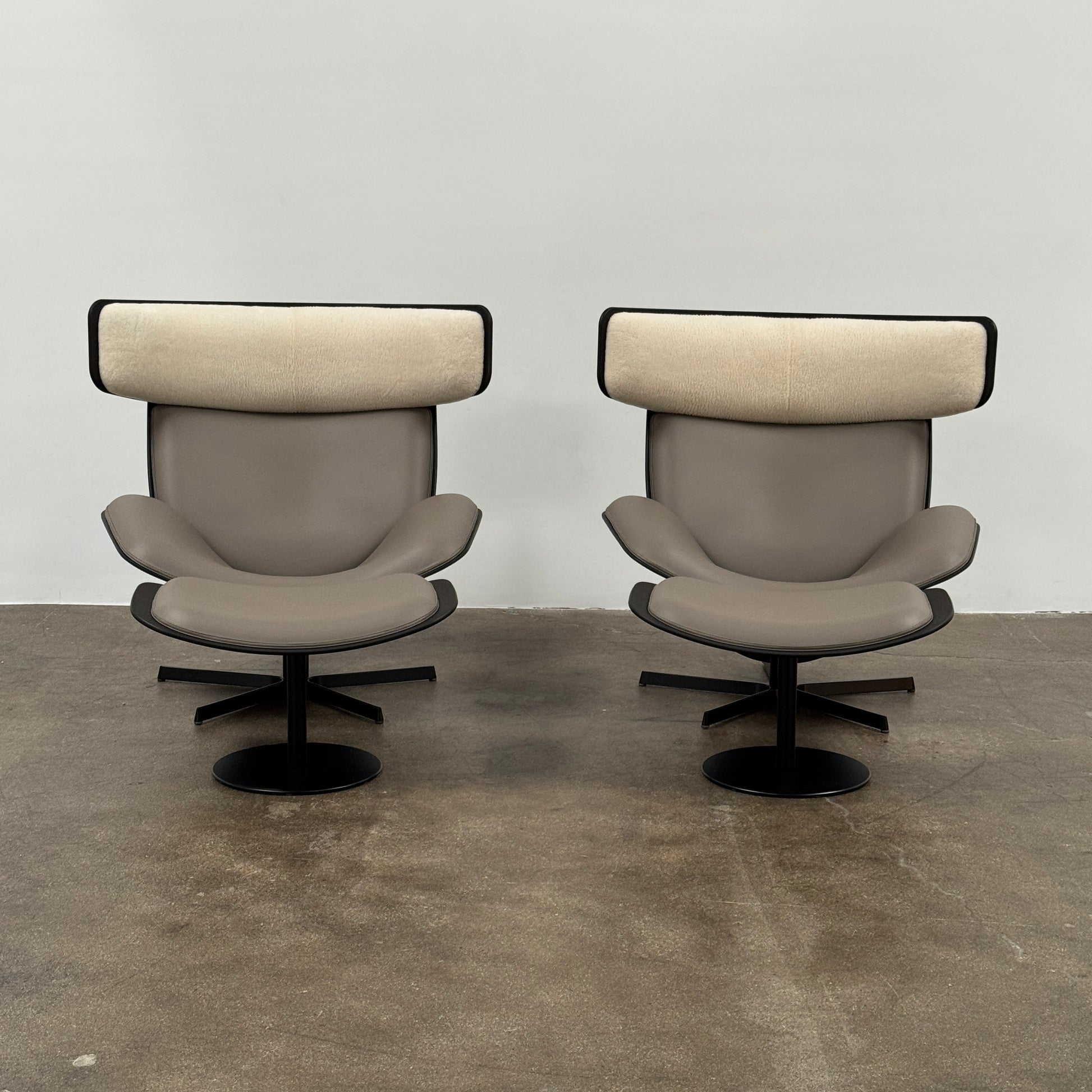 The B&B Italia Almora Chair and Ottoman in modern gray and black are swivel lounge pieces by B&B Italia, displayed on a white background.