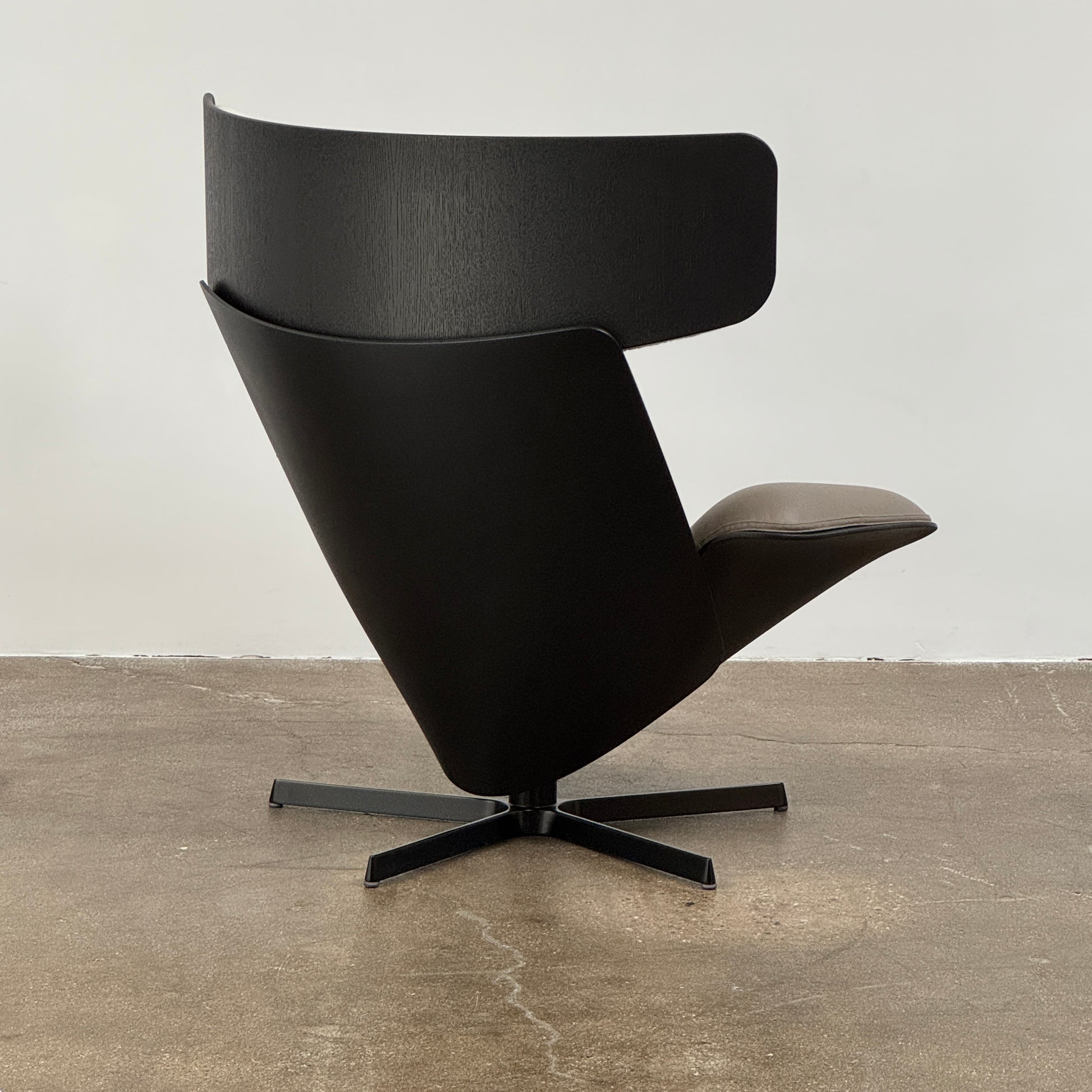 The B&B Italia Almora Chair and Ottoman in modern gray and black are swivel lounge pieces by B&B Italia, displayed on a white background.