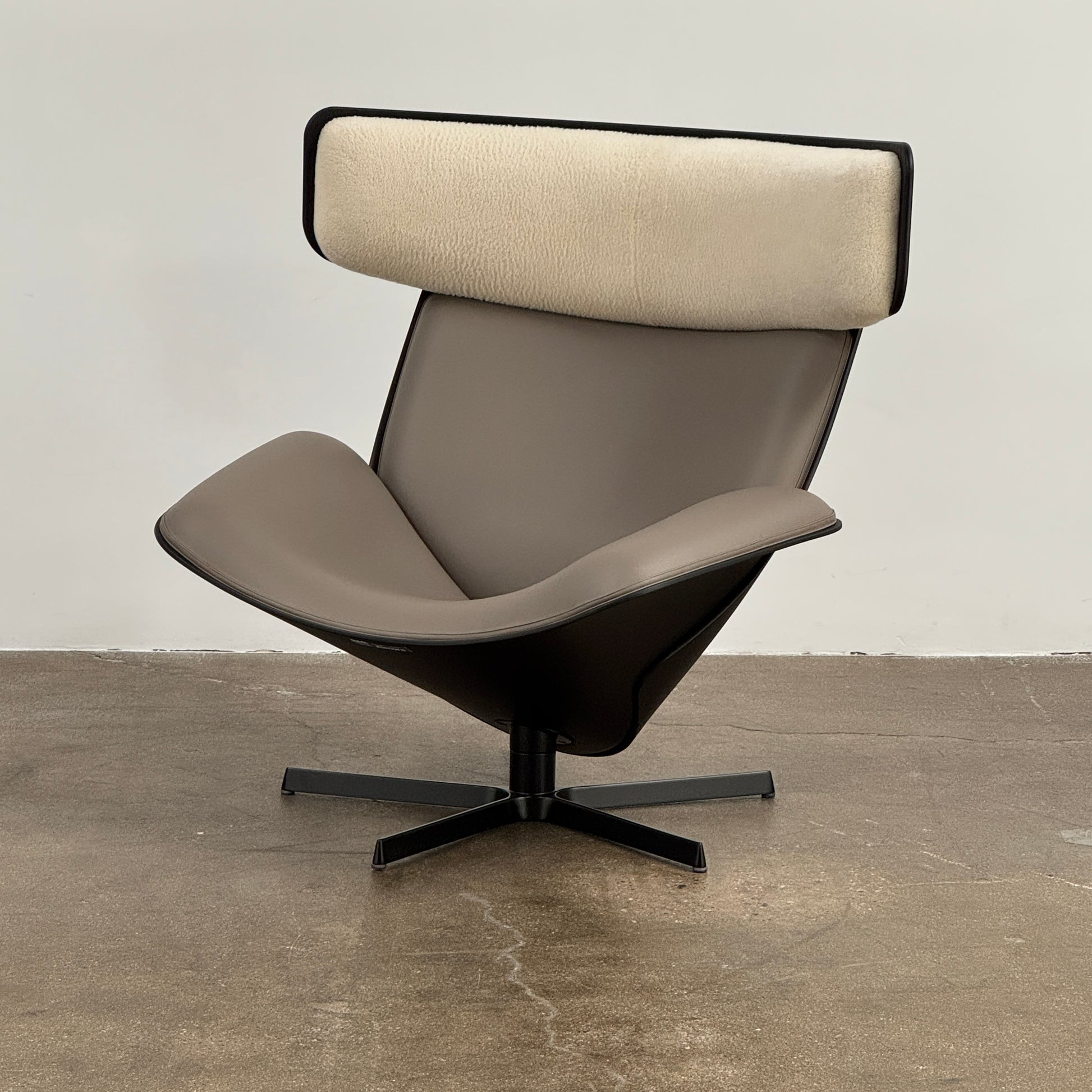 The B&B Italia Almora Chair and Ottoman in modern gray and black are swivel lounge pieces by B&B Italia, displayed on a white background.