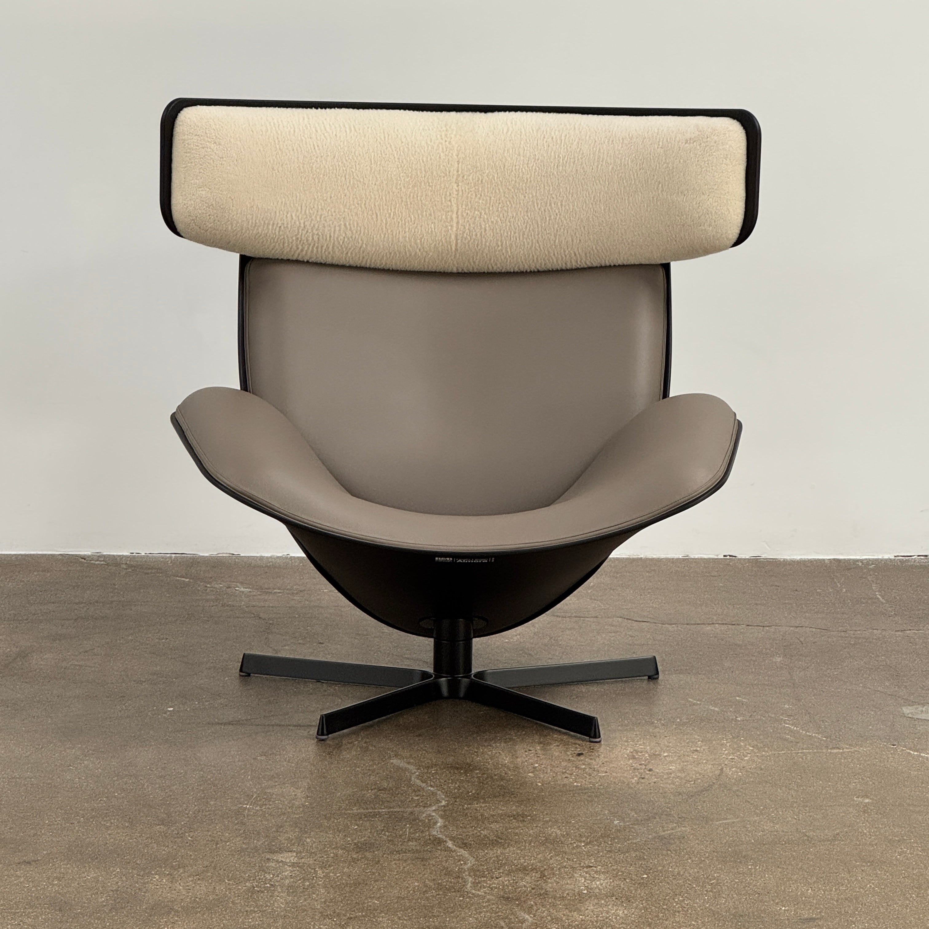 The B&B Italia Almora Chair and Ottoman in modern gray and black are swivel lounge pieces by B&B Italia, displayed on a white background.