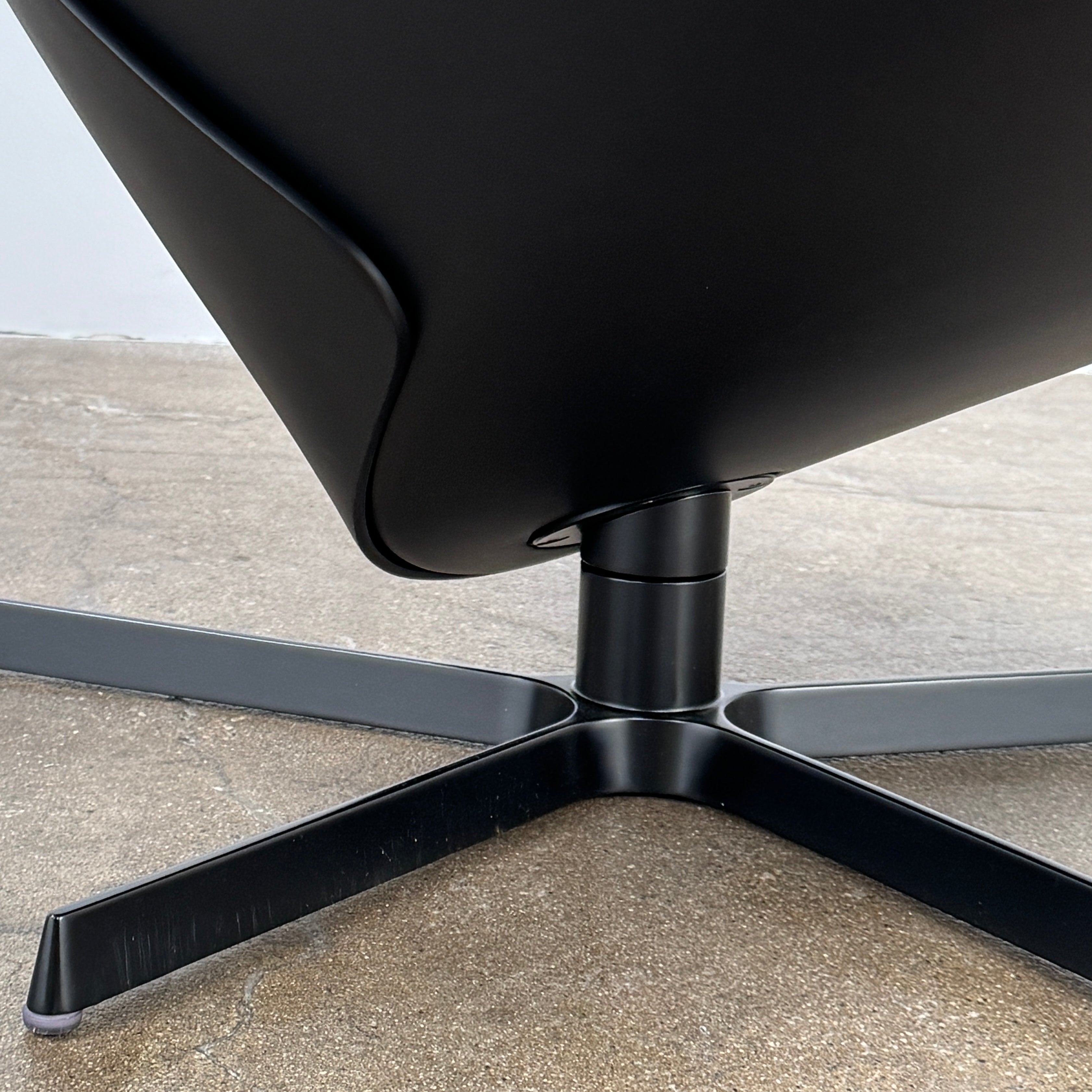 The B&B Italia Almora Chair and Ottoman in modern gray and black are swivel lounge pieces by B&B Italia, displayed on a white background.