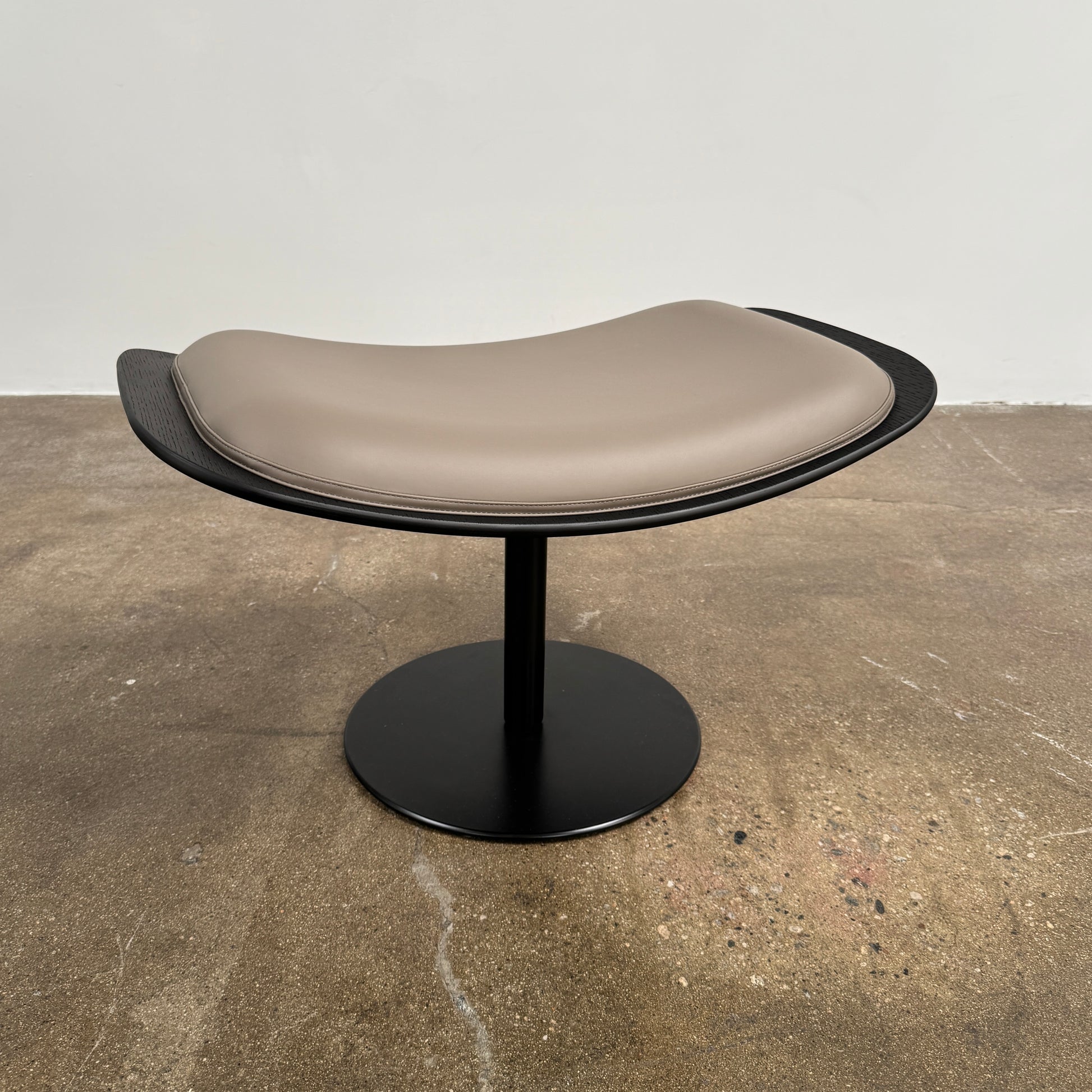 The B&B Italia Almora Chair and Ottoman in modern gray and black are swivel lounge pieces by B&B Italia, displayed on a white background.